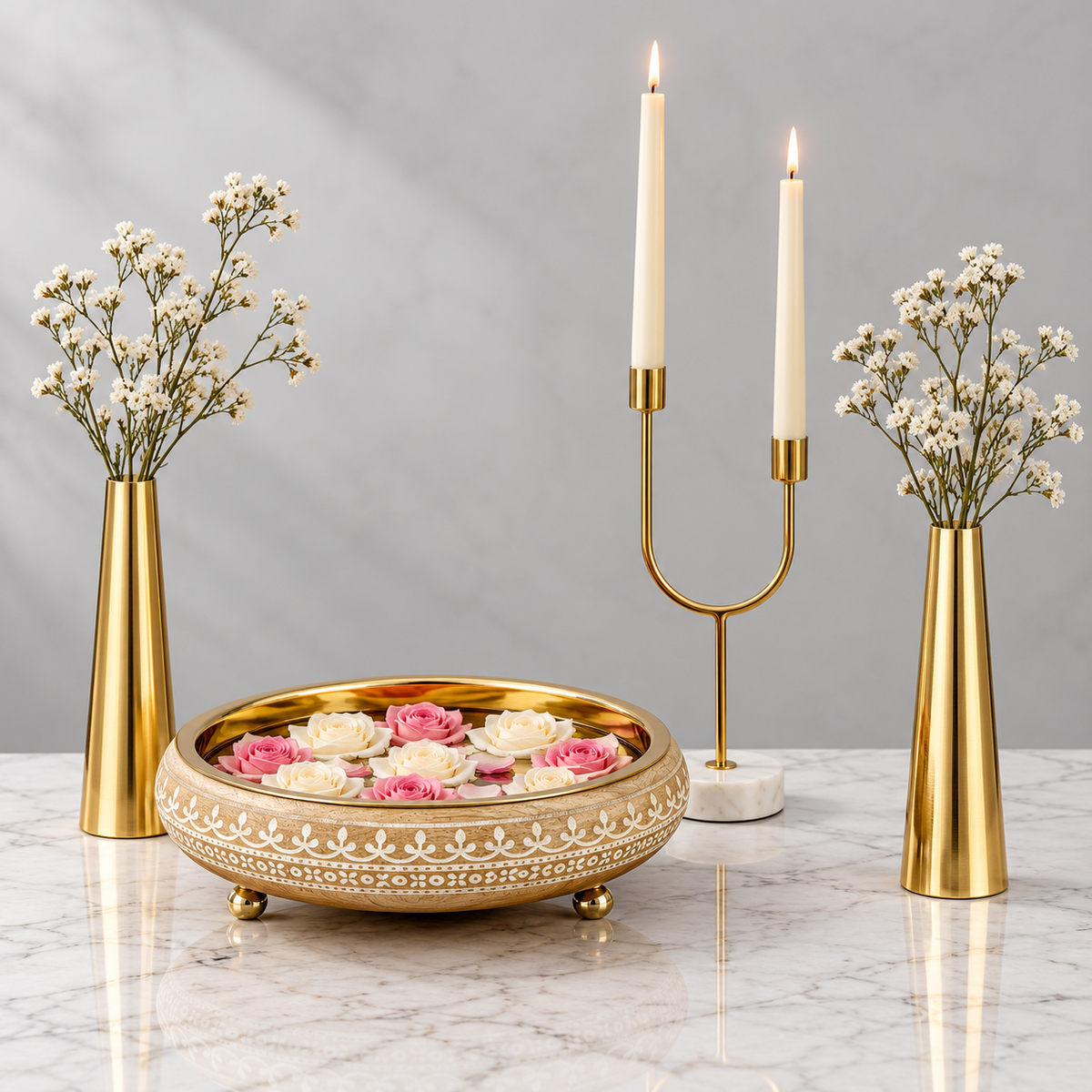 Virasat Urli Console Styling Set - ivory and gold urli, two gold slim cone vases and a dual arc candle holder on marble