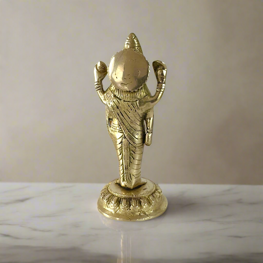 Product image of a Brass Dhanvantri Idol from Indian Impressions, showcasing Lord Dhanvantri in a standing posture holding sacred items. The idol is intricately crafted with fine details and features a polished brass finish, ideal for Vastu, spiritual practices, home décor, or gifting to promote health and well-being.