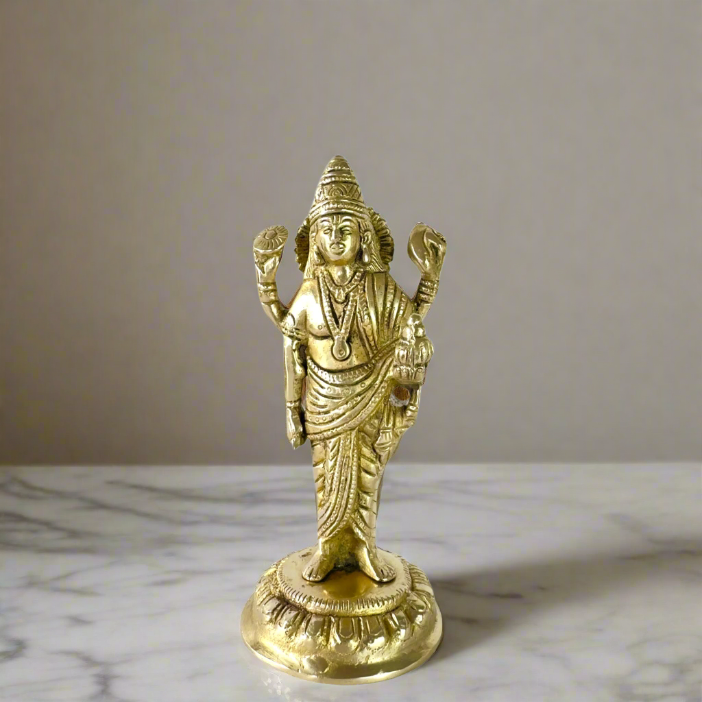 Product image of a Brass Dhanvantri Idol from Indian Impressions, showcasing Lord Dhanvantri in a standing posture holding sacred items. The idol is intricately crafted with fine details and features a polished brass finish, ideal for Vastu, spiritual practices, home décor, or gifting to promote health and well-being.