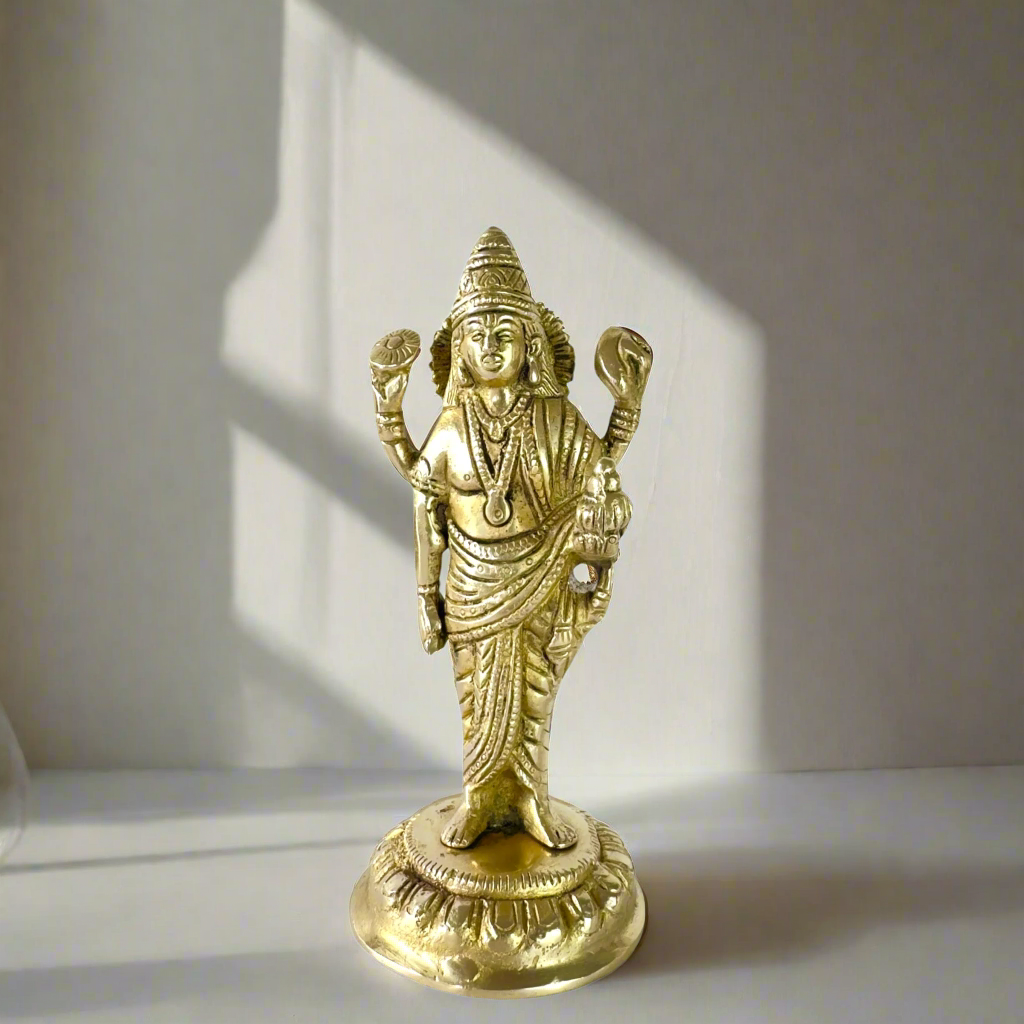 Product image of a Brass Dhanvantri Idol from Indian Impressions, showcasing Lord Dhanvantri in a standing posture holding sacred items. The idol is intricately crafted with fine details and features a polished brass finish, ideal for Vastu, spiritual practices, home décor, or gifting to promote health and well-being.