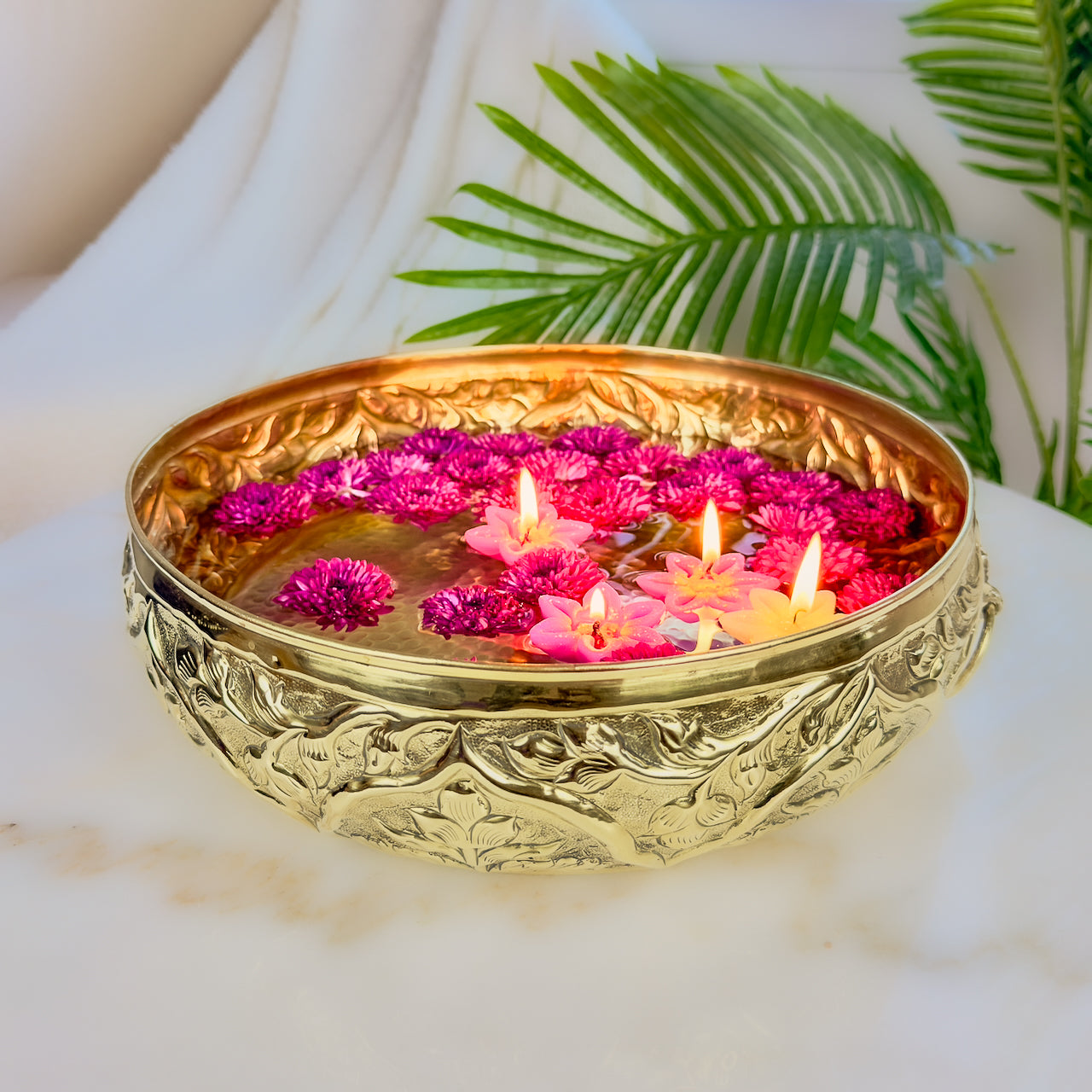 Product image of a Brass Gulmohar Urli from Indian Impressions, featuring a beautifully crafted design with intricate floral detailing. The urli has a polished brass finish, ideal for adding a touch of elegance to home décor, spiritual rituals, or gifting, and is perfect for enhancing the ambiance of any space.