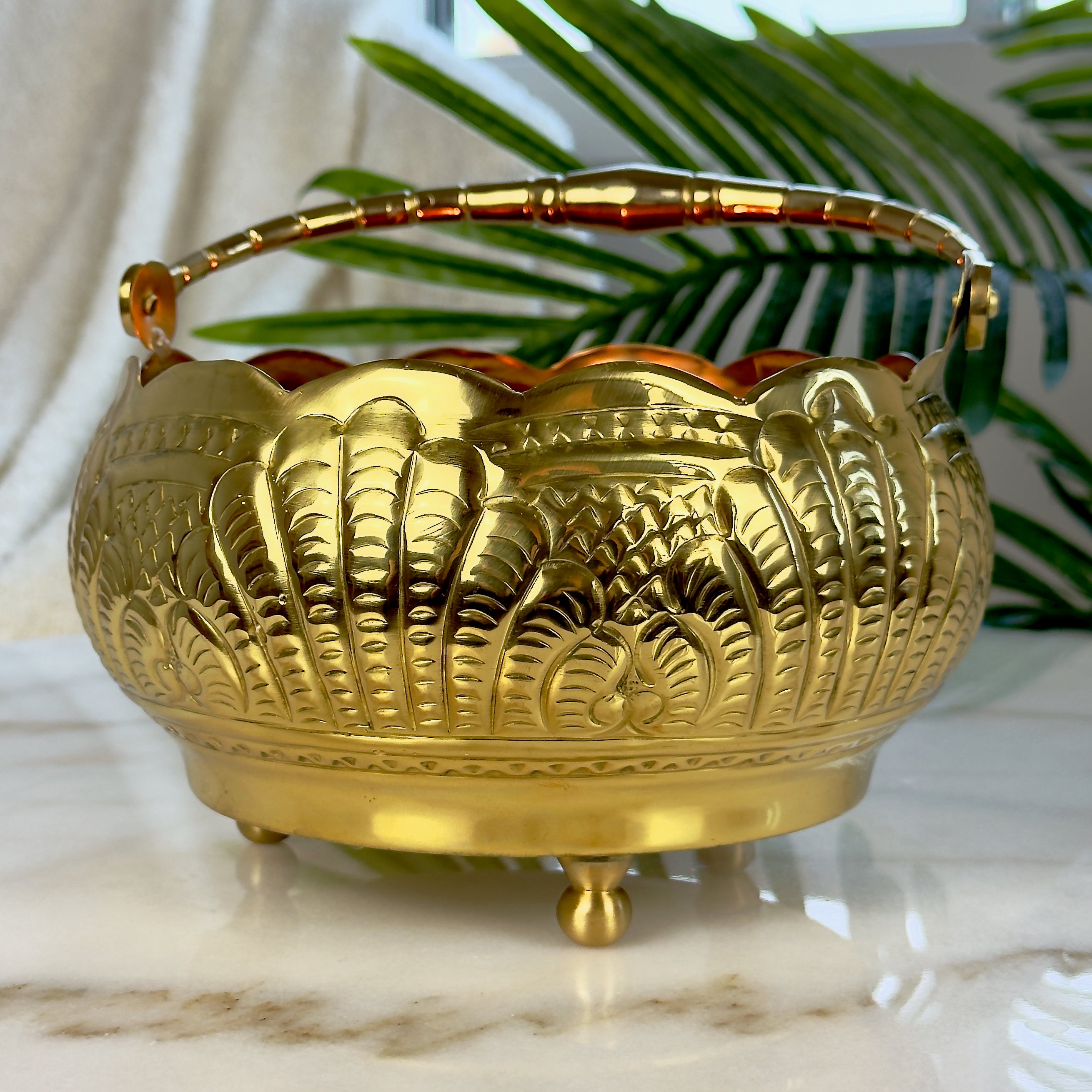 Product image of a Puspam Brass Flower Basket from Indian Impressions, featuring an intricately handcrafted design with traditional motifs. Made from polished brass, this elegant basket is perfect for holding flowers, enhancing Vastu energy, festive décor, or gifting, adding a touch of charm and positivity to any space.