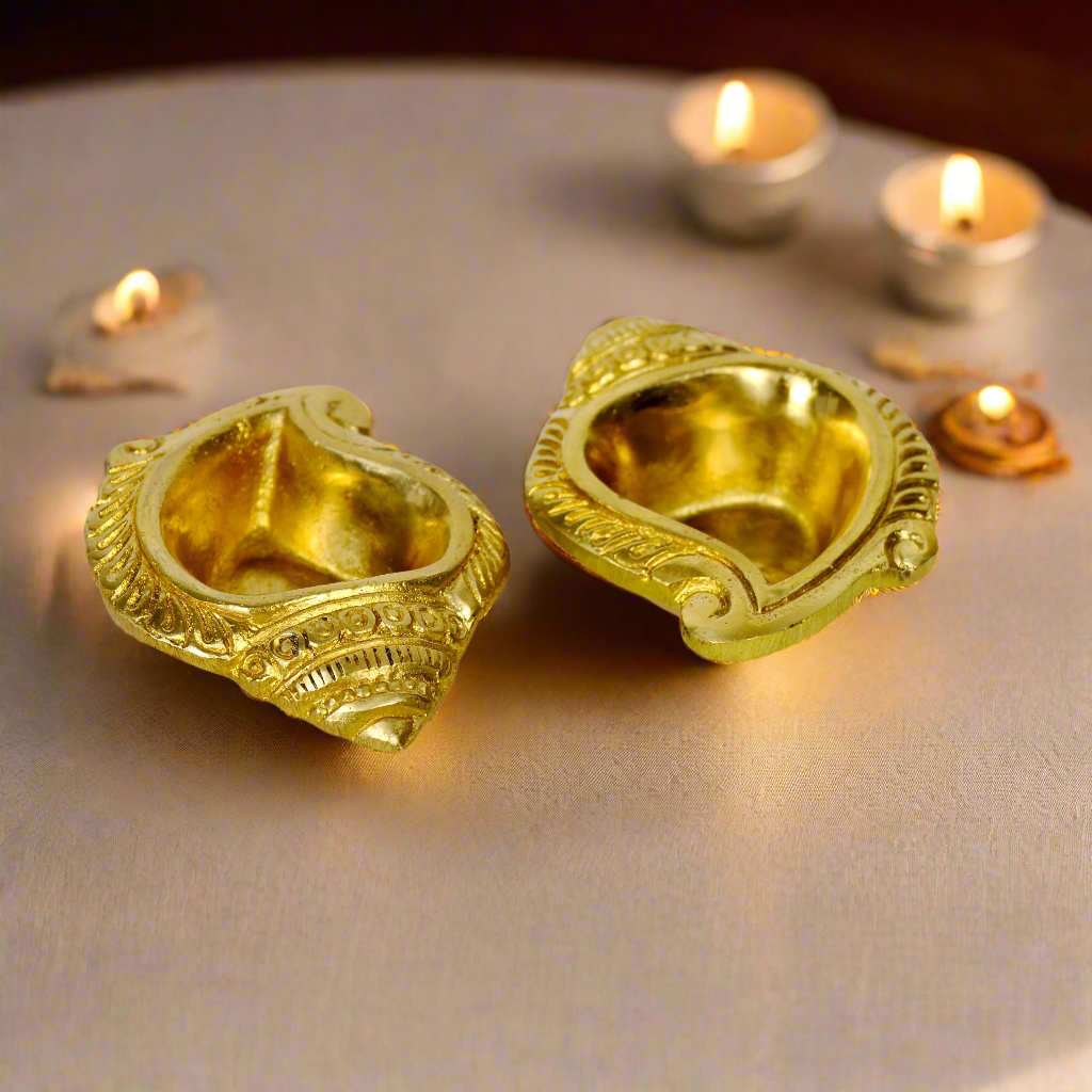 Product image of a Brass Shankh Diya from Indian Impressions, featuring a beautifully crafted conch shell design with intricate detailing. Made from polished brass, this diya is perfect for Vastu, spiritual rituals, home décor, or gifting, symbolizing purity, positivity, and divine energy.