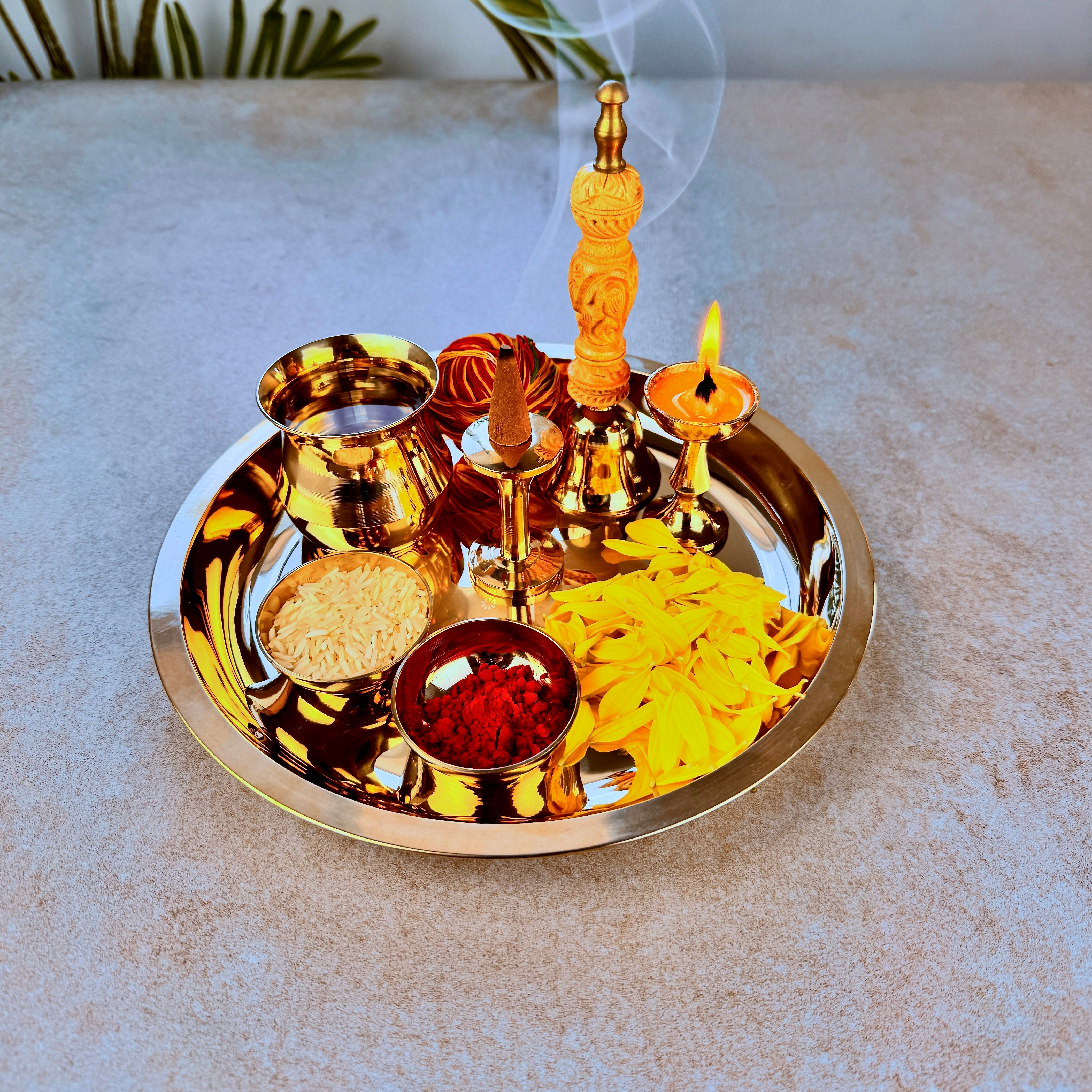 Product image of a Bronze Pooja Thali Set from Indian Impressions, featuring a beautifully handcrafted design. The set includes a thali, diya, incense holder, and small bowls, all crafted from polished bronze. Perfect for Vastu, spiritual rituals, home décor, or gifting, it adds a traditional and elegant touch to any sacred space.