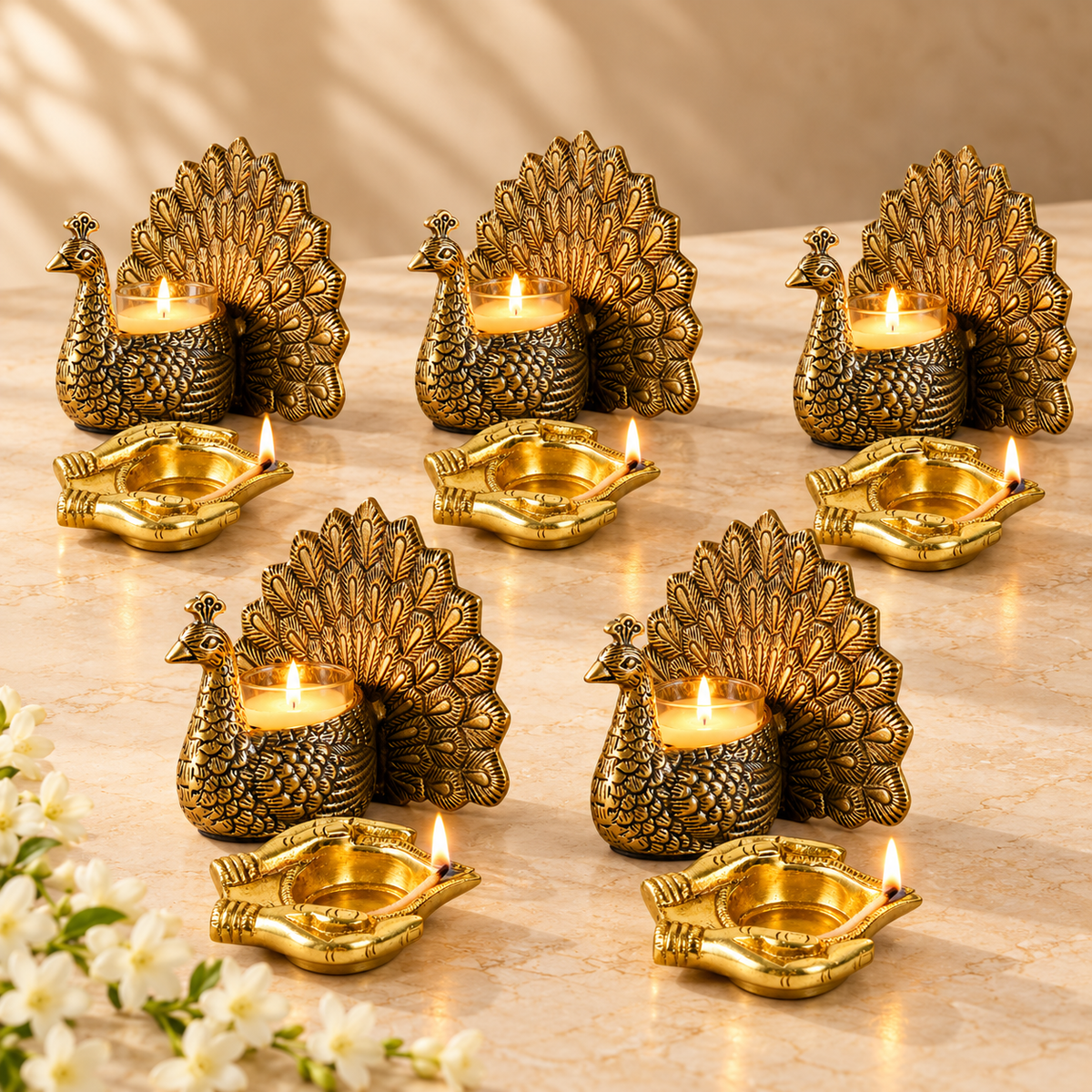 Five brass peacock tealight holders paired with five brass oil lamps as ready-to-give Diwali gifts