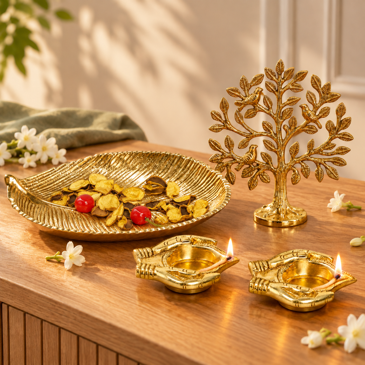 Brass Kalpvriksh tree of life on a timber sideboard with a gold leaf platter and two lit brass lamps