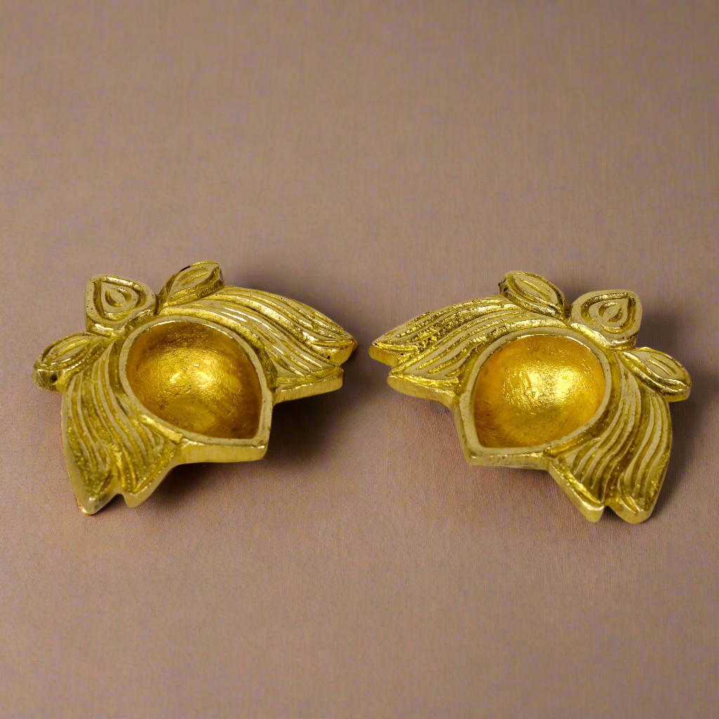 Product image of a Brass Lotus Diya from Indian Impressions, featuring an elegant lotus-shaped design with intricate detailing. The diya is crafted from polished brass, making it ideal for holding oil or ghee for spiritual rituals, enhancing the ambiance of any space. Perfect for Vastu, home décor, or gifting, it symbolizes purity and divine light.