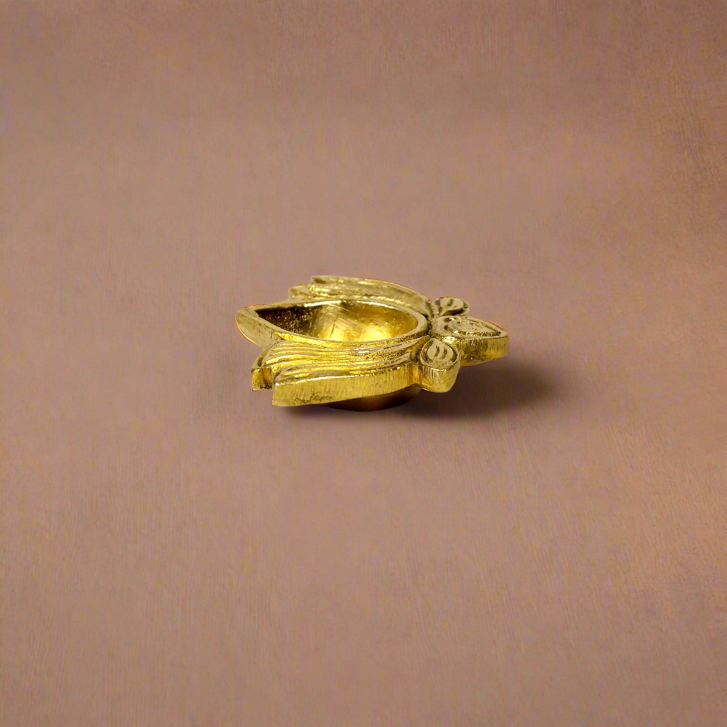 Product image of a Brass Lotus Diya from Indian Impressions, featuring an elegant lotus-shaped design with intricate detailing. The diya is crafted from polished brass, making it ideal for holding oil or ghee for spiritual rituals, enhancing the ambiance of any space. Perfect for Vastu, home décor, or gifting, it symbolizes purity and divine light.