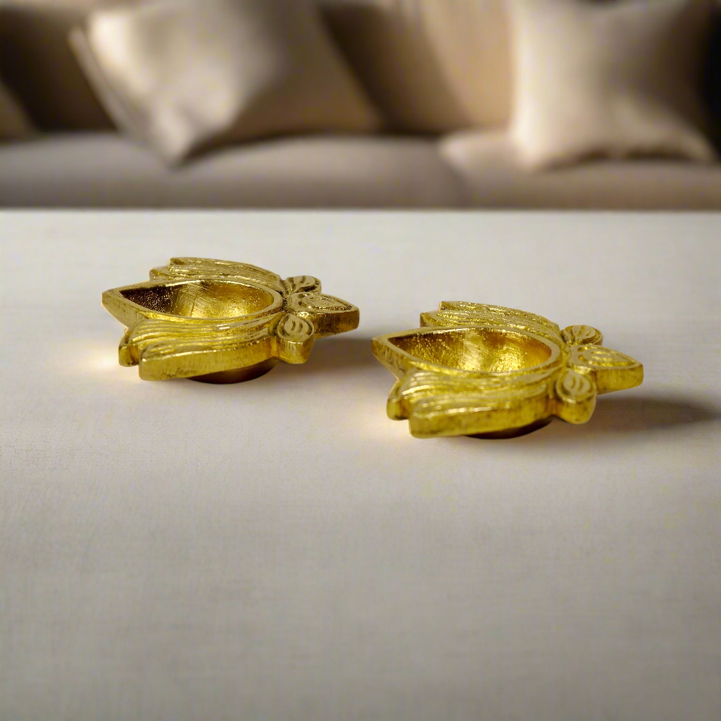 Product image of a Brass Lotus Diya from Indian Impressions, featuring an elegant lotus-shaped design with intricate detailing. The diya is crafted from polished brass, making it ideal for holding oil or ghee for spiritual rituals, enhancing the ambiance of any space. Perfect for Vastu, home décor, or gifting, it symbolizes purity and divine light.