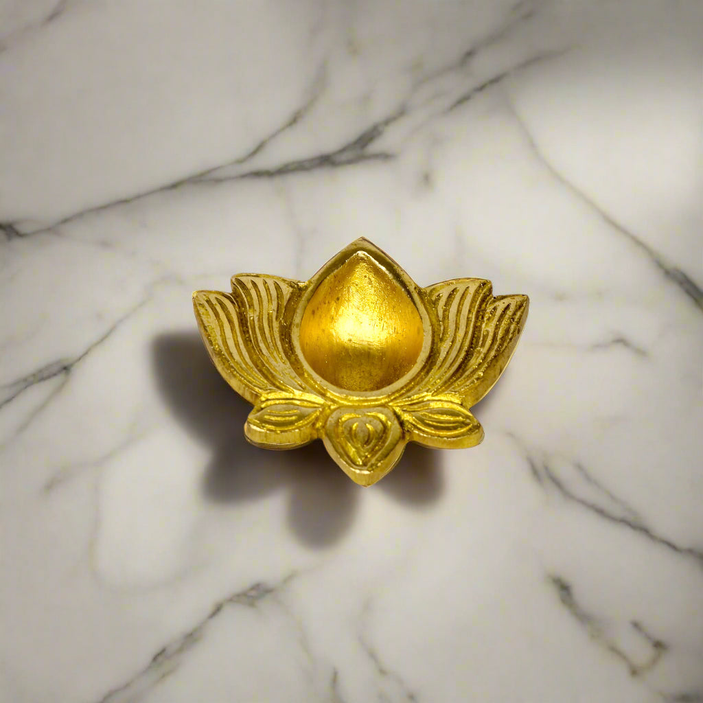 Product image of a Brass Lotus Diya from Indian Impressions, featuring an elegant lotus-shaped design with intricate detailing. The diya is crafted from polished brass, making it ideal for holding oil or ghee for spiritual rituals, enhancing the ambiance of any space. Perfect for Vastu, home décor, or gifting, it symbolizes purity and divine light.
