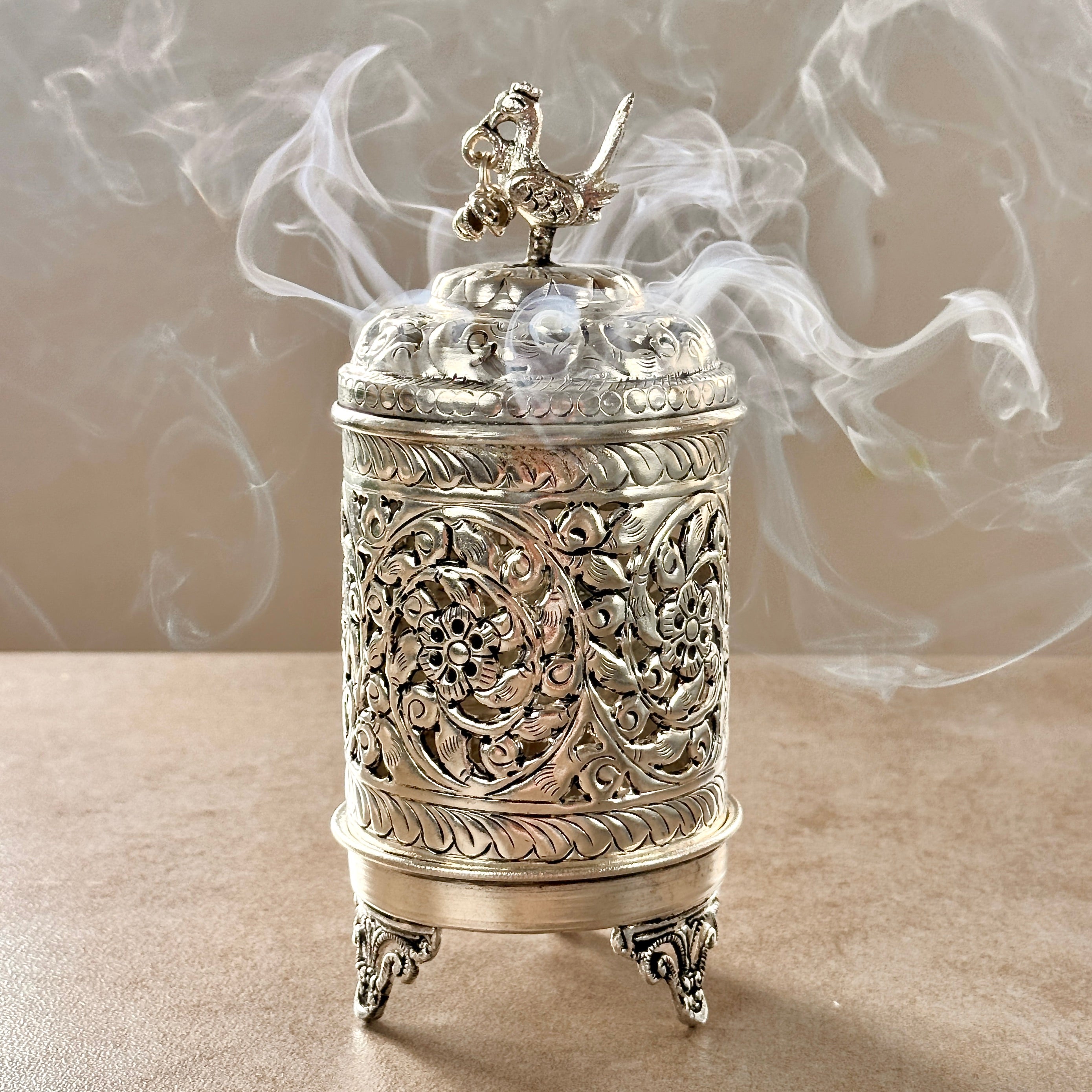 Product image of the Mayur Jyoti Dhuna in German Silver from Indian Impressions, featuring an intricately designed peacock-shaped incense burner that can also be used as a diya. Ideal for Vastu, spiritual rituals, and home décor, bringing positivity, elegance, and a divine ambiance to any space.