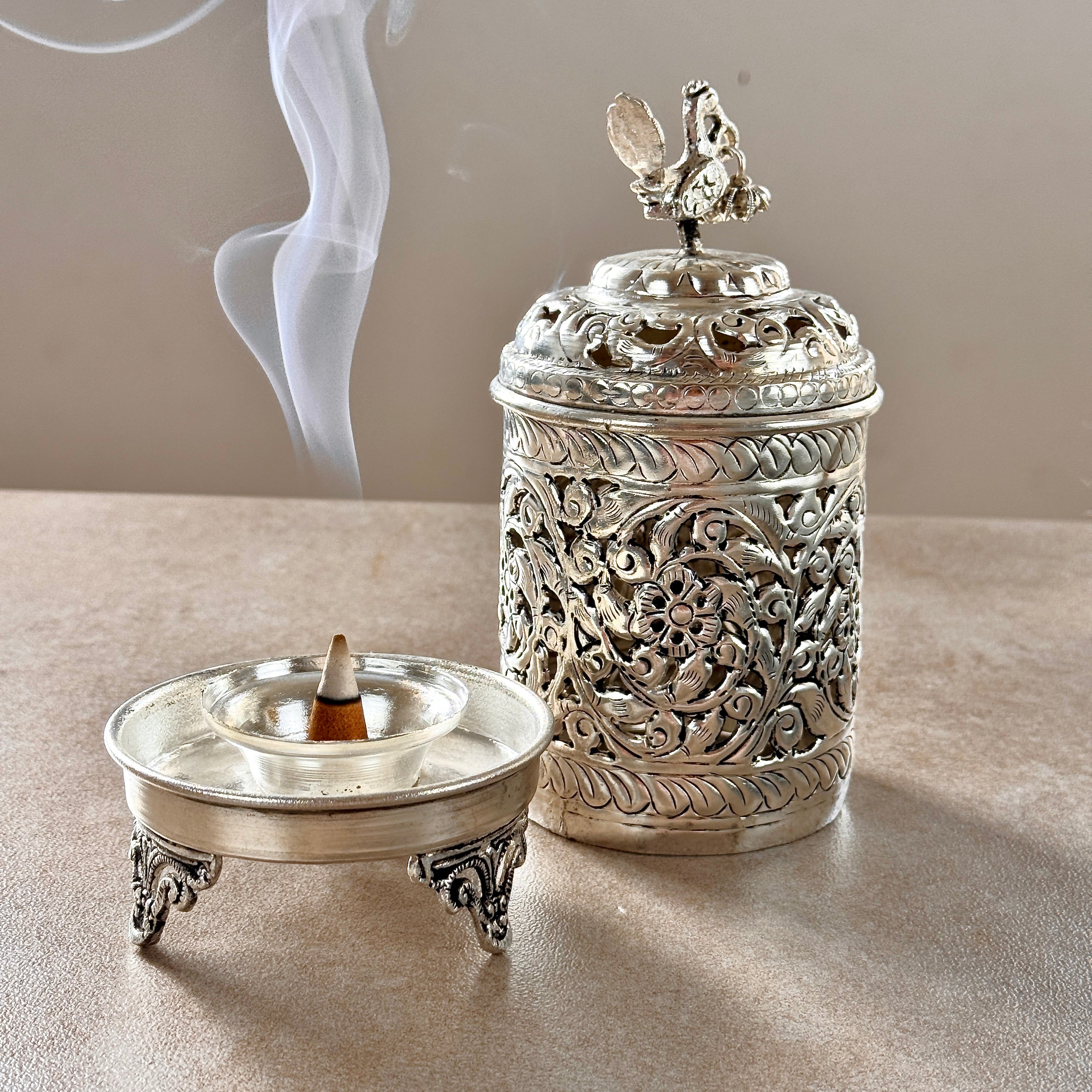 Product image of the Mayur Jyoti Dhuna in German Silver from Indian Impressions, featuring an intricately designed peacock-shaped incense burner that can also be used as a diya. Ideal for Vastu, spiritual rituals, and home décor, bringing positivity, elegance, and a divine ambiance to any space.