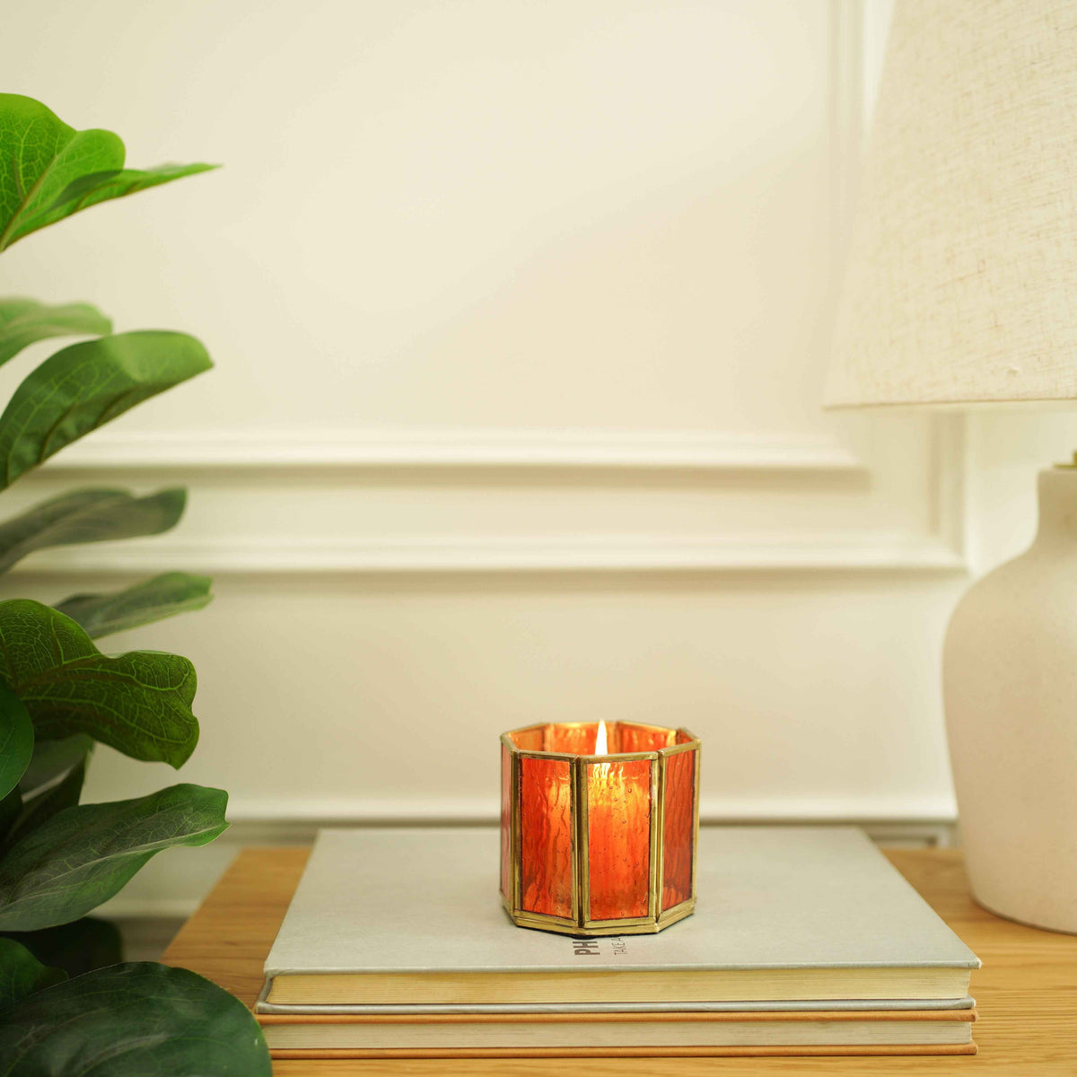 Two orange glass votive holders in brass frames, set of 2