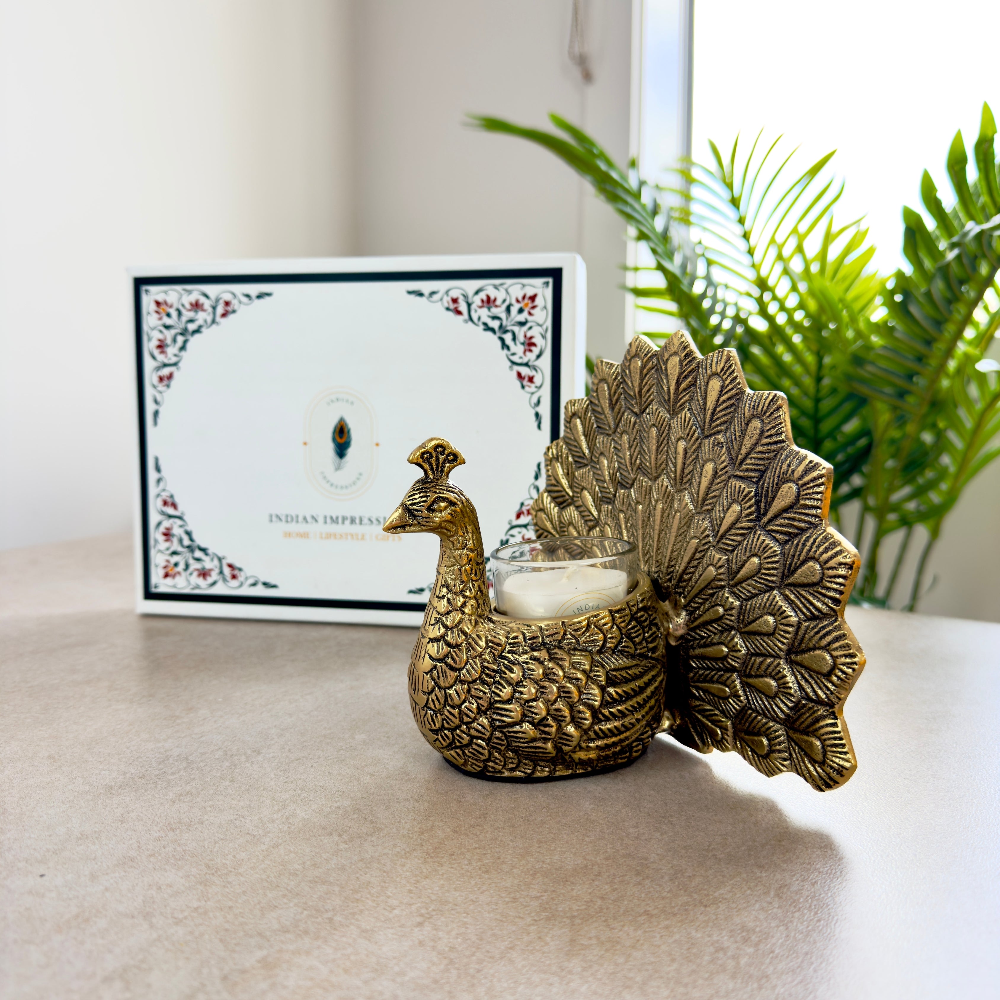 Product image of the Peacock Candle Holder with Antique Brass Finish from Indian Impressions, showcasing a stunning peacock design with intricate detailing and a vintage-inspired finish. Ideal for holding candles, this piece is perfect for Vastu, home décor, festive occasions, or gifting, adding elegance and positive energy to any space.