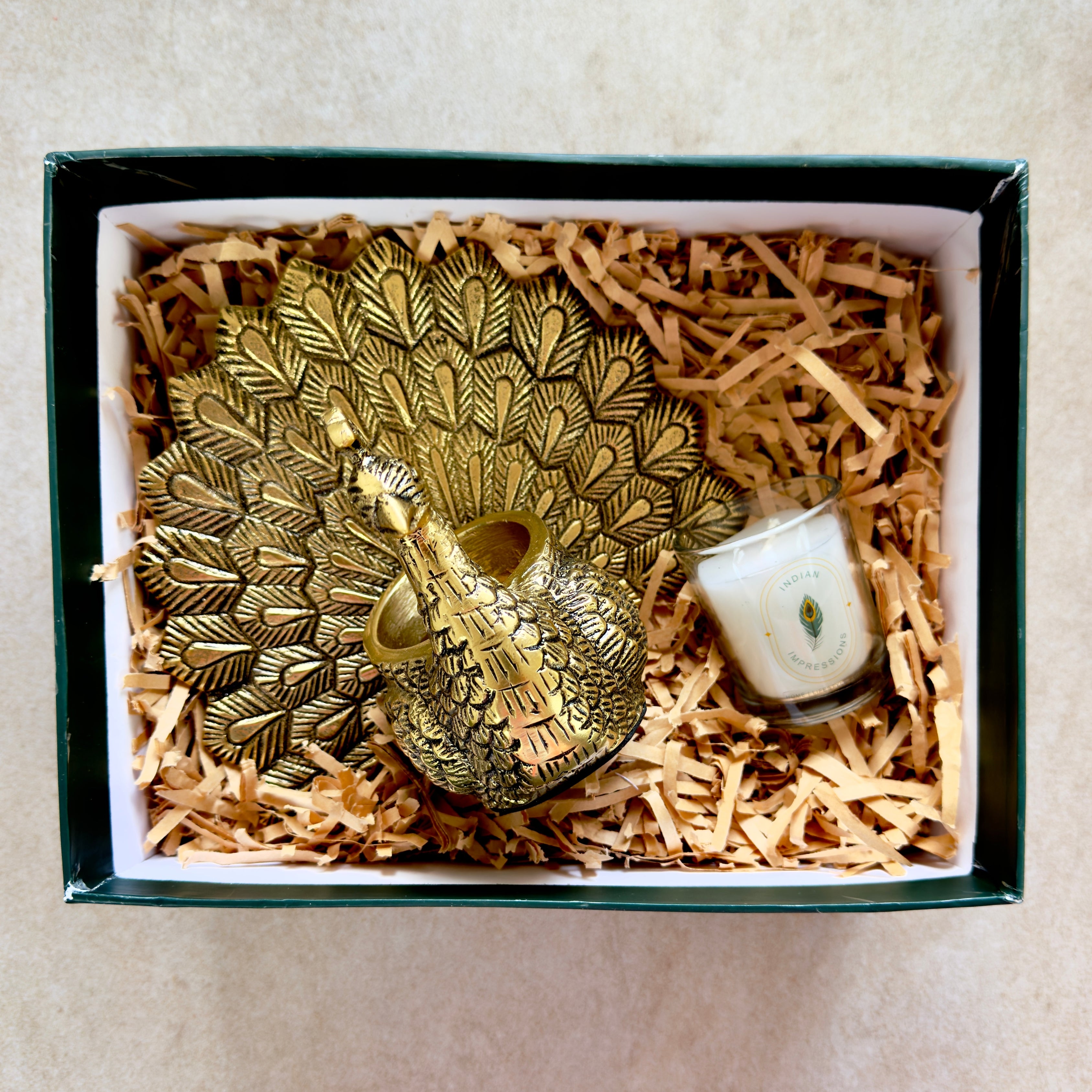 Product image of the Peacock Candle Holder with Antique Brass Finish from Indian Impressions, showcasing a stunning peacock design with intricate detailing and a vintage-inspired finish. Ideal for holding candles, this piece is perfect for Vastu, home décor, festive occasions, or gifting, adding elegance and positive energy to any space.
