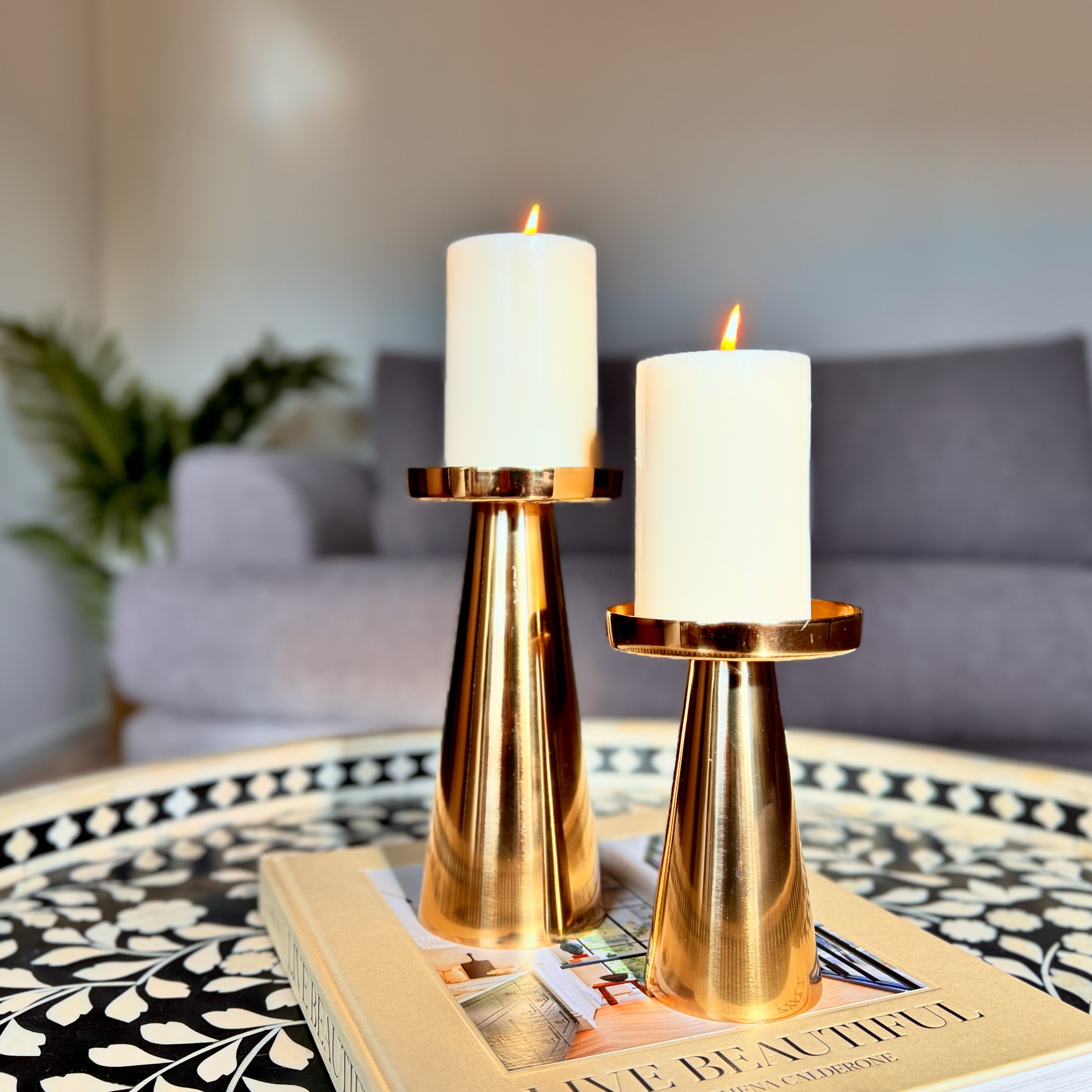 Product image of a Metal Candle Holder Set of 2 from Indian Impressions, featuring elegantly crafted holders with a polished finish. Designed for pillar or taper candles, these holders add a touch of sophistication to any setting. Perfect for Vastu, home décor, festive occasions, or gifting.