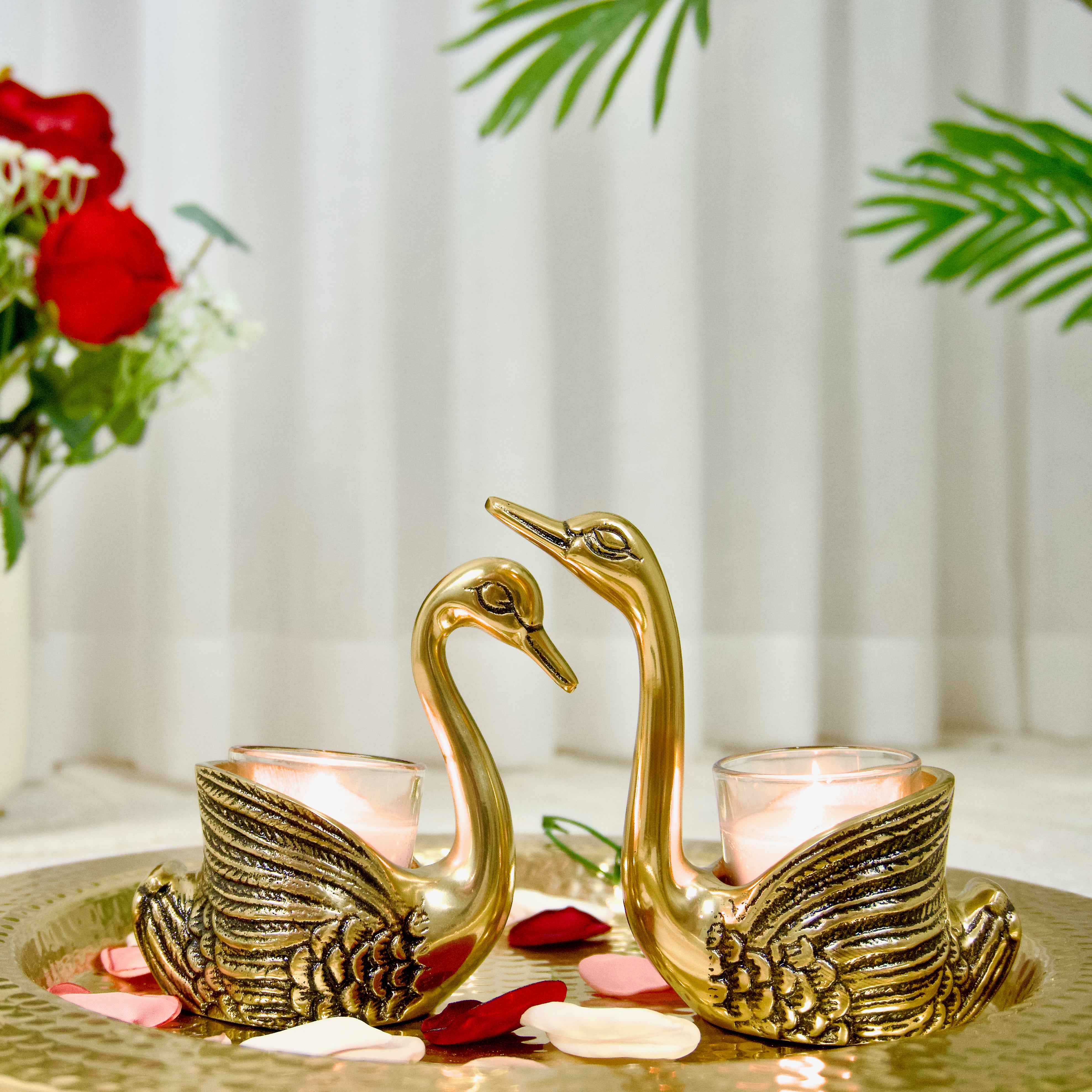 Two gold swan-shaped candle holders