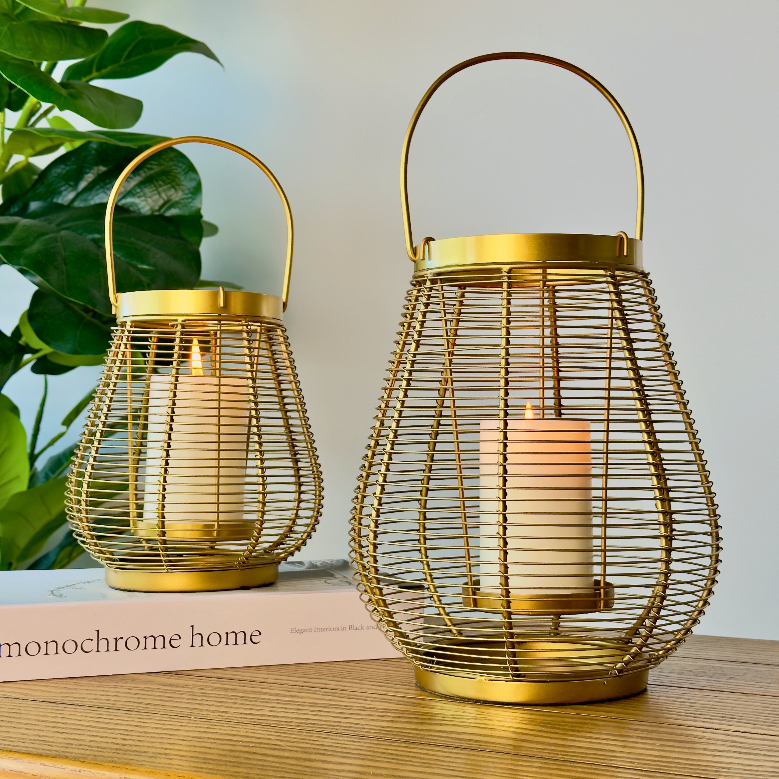 Product image of a Metal Cage Lantern from Indian Impressions, featuring a sleek, openwork cage design with a polished finish. This lantern is ideal for holding candles or LED lights, adding a warm and elegant ambiance to any space. Perfect for Vastu, home décor, or gifting.