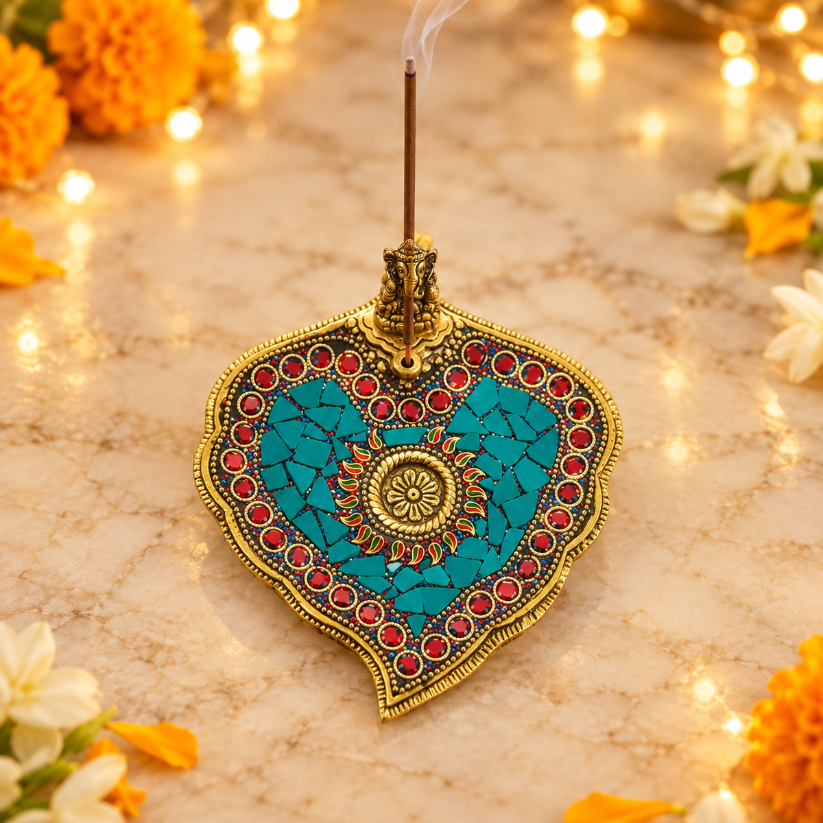 Ganesha agarbatti holder with incense stick in festive marigold and jasmine setting