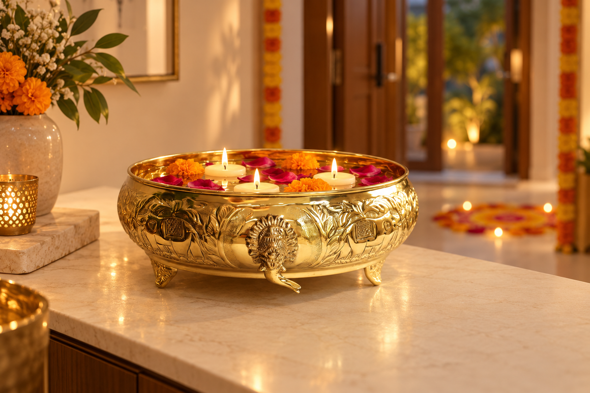 Gajgamini brass urli with floating candles, marigolds and rose petals in a Diwali-decorated entryway.