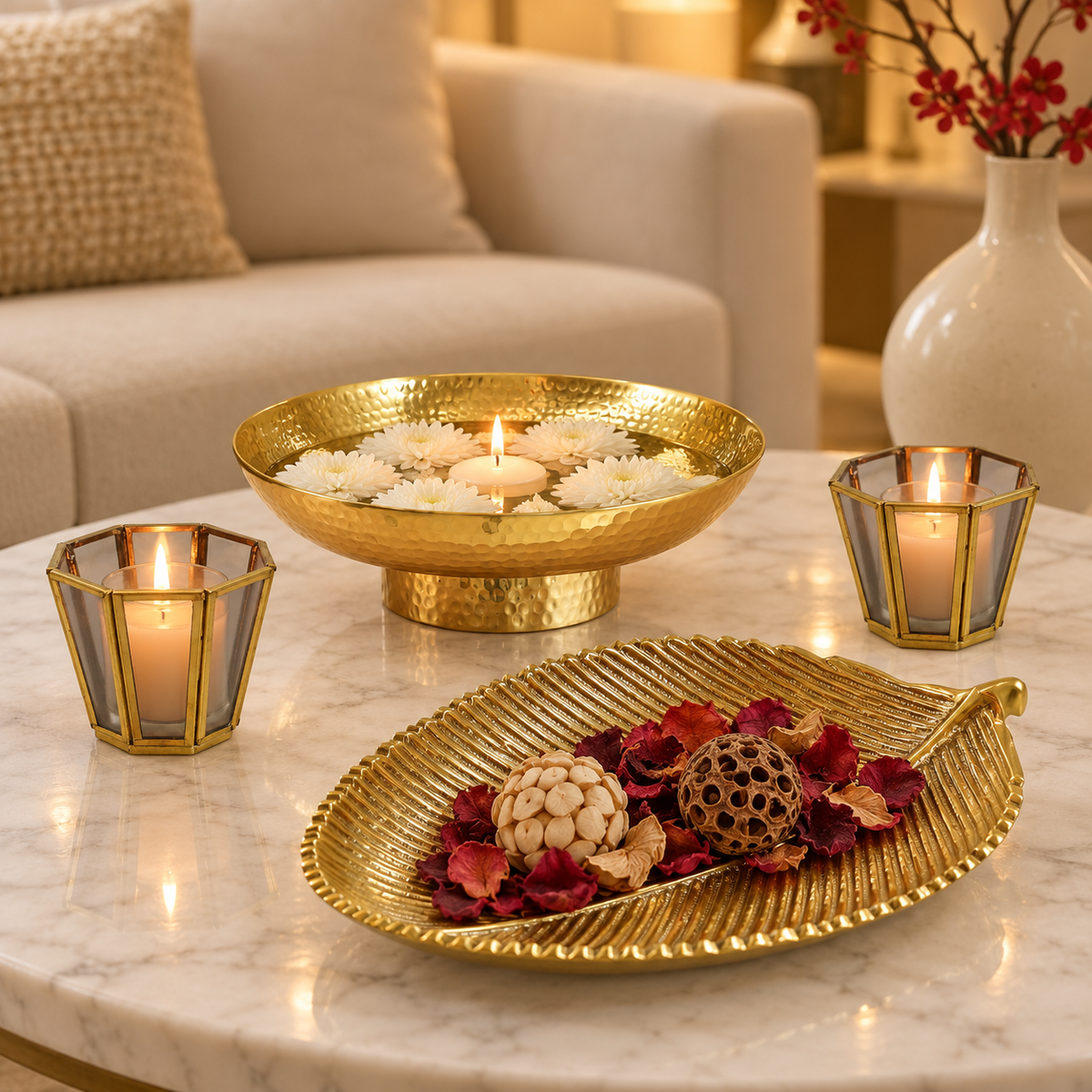 Kanchan gold urli with floating tealights and grey glass votives