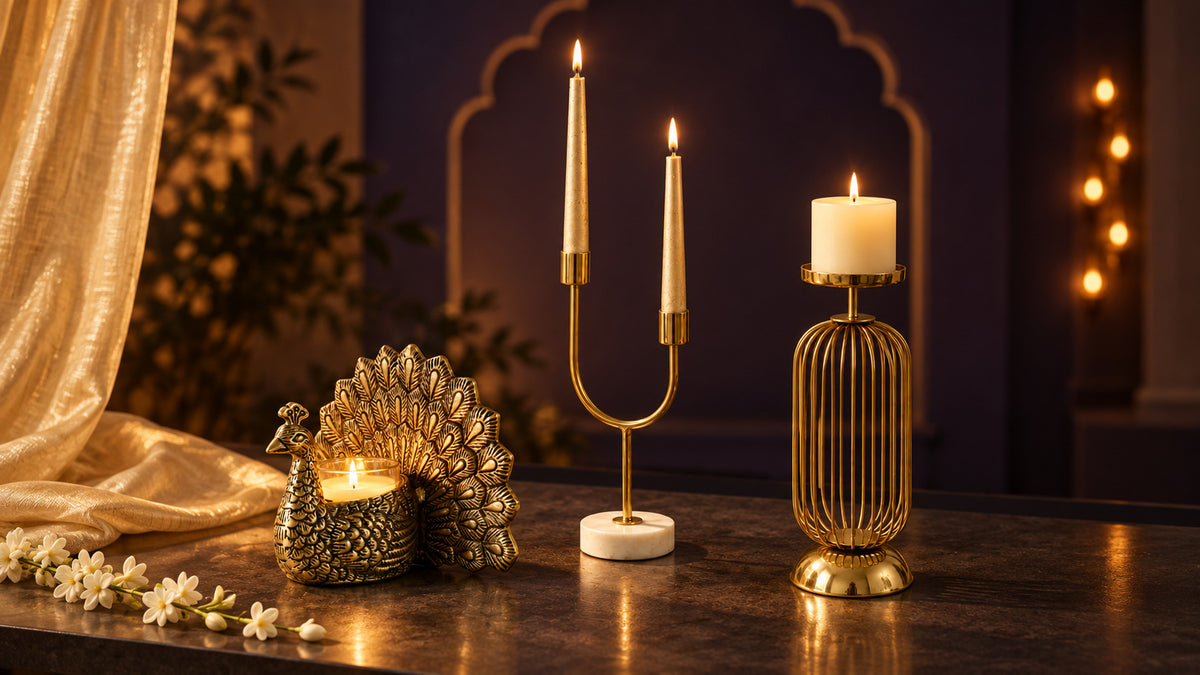 Brass peacock tealight holder, gold arc dual candle holder and gold cage pillar candle holder lit at night