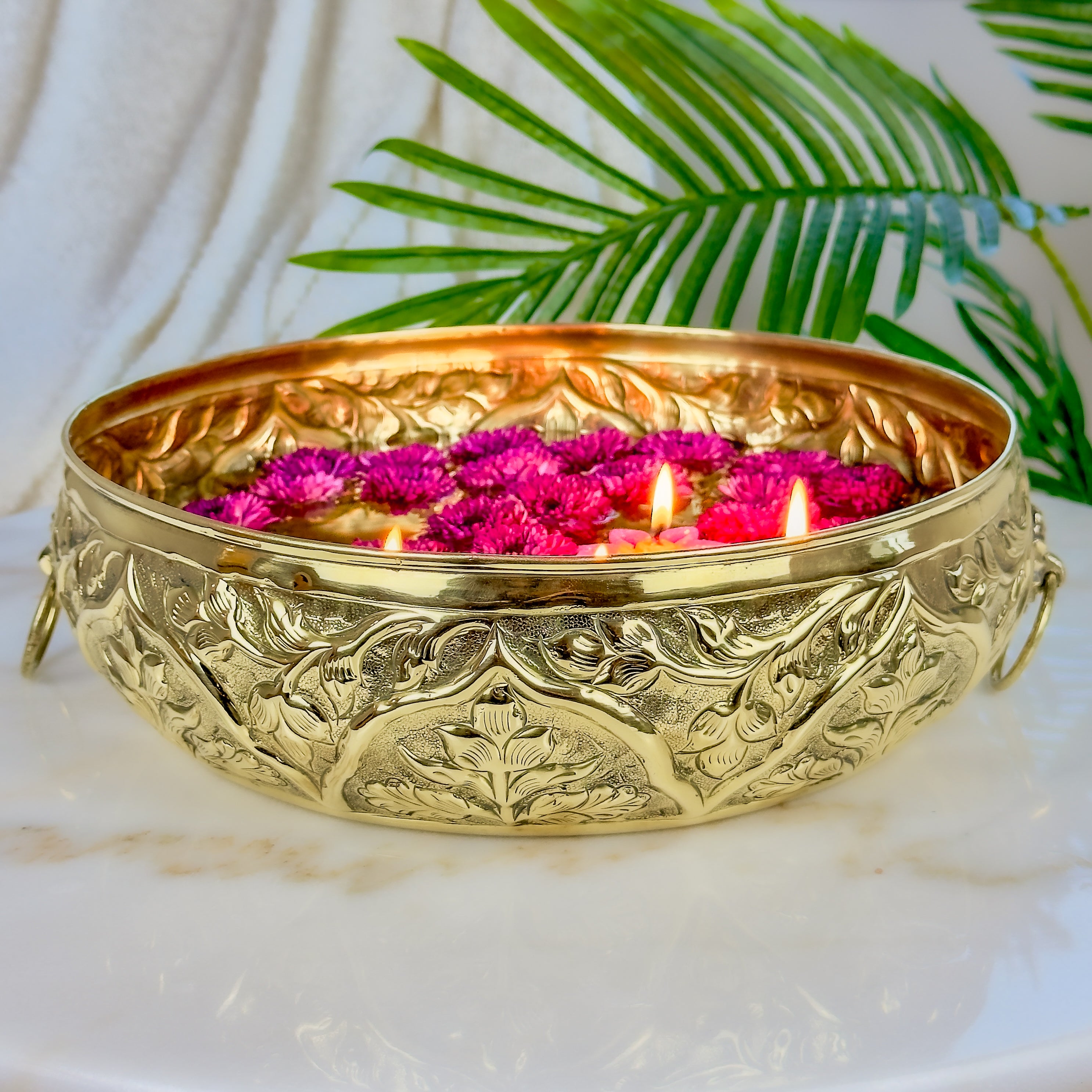 Product image of a Brass Gulmohar Urli from Indian Impressions, featuring a beautifully crafted design with intricate floral detailing. The urli has a polished brass finish, ideal for adding a touch of elegance to home décor, spiritual rituals, or gifting, and is perfect for enhancing the ambiance of any space.