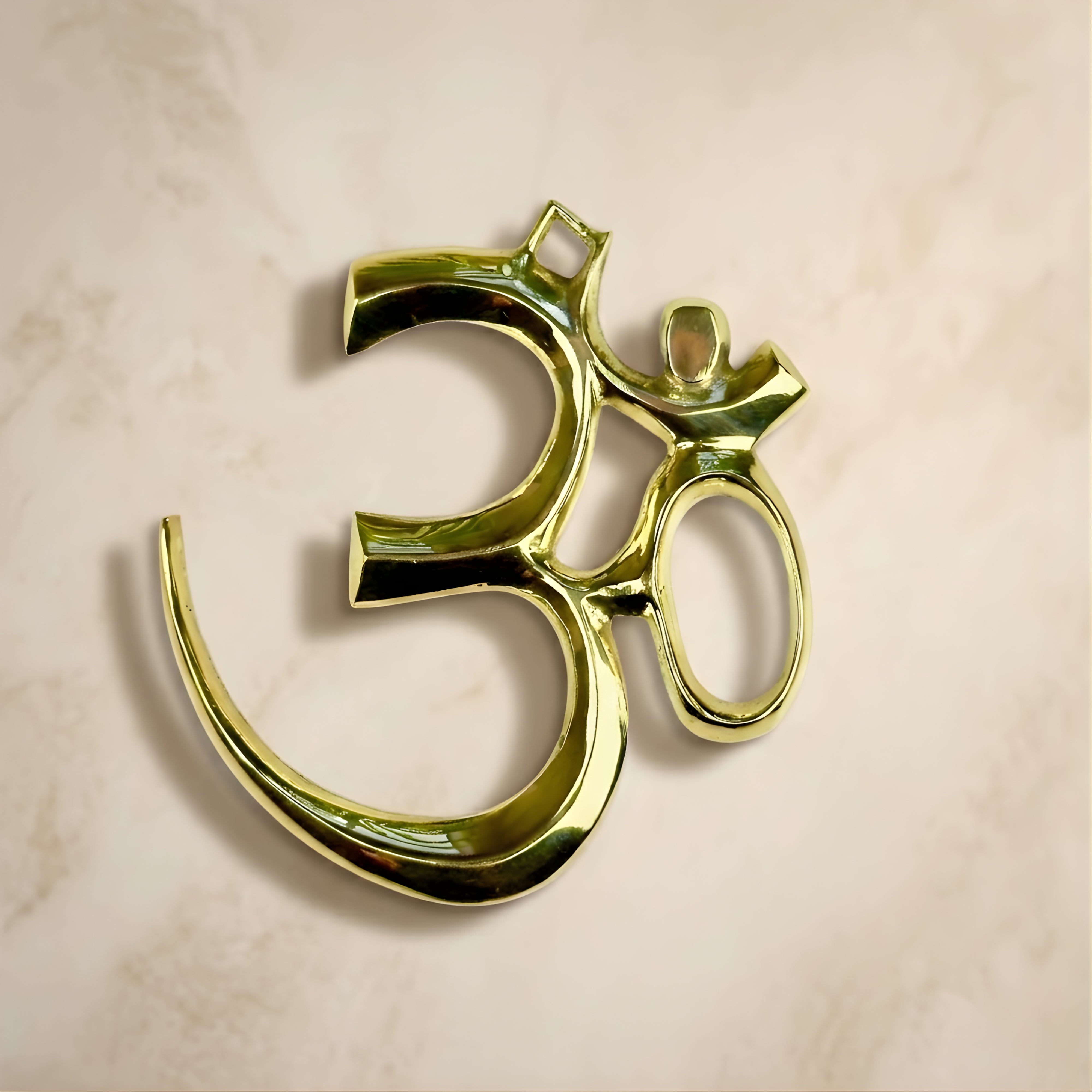 Handcrafted polished brass Om symbol wall-hanging, premium spiritual home decor by Indian Impressions.