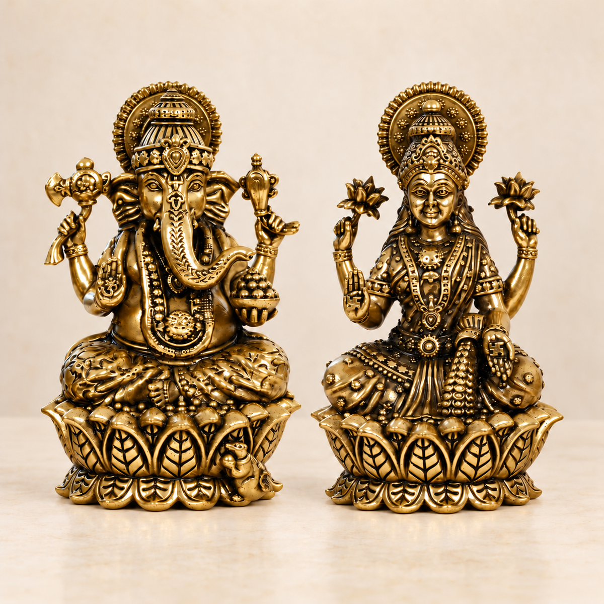 Brass Lakshmi and Ganesha idols seated on lotus bases, antique gold finish