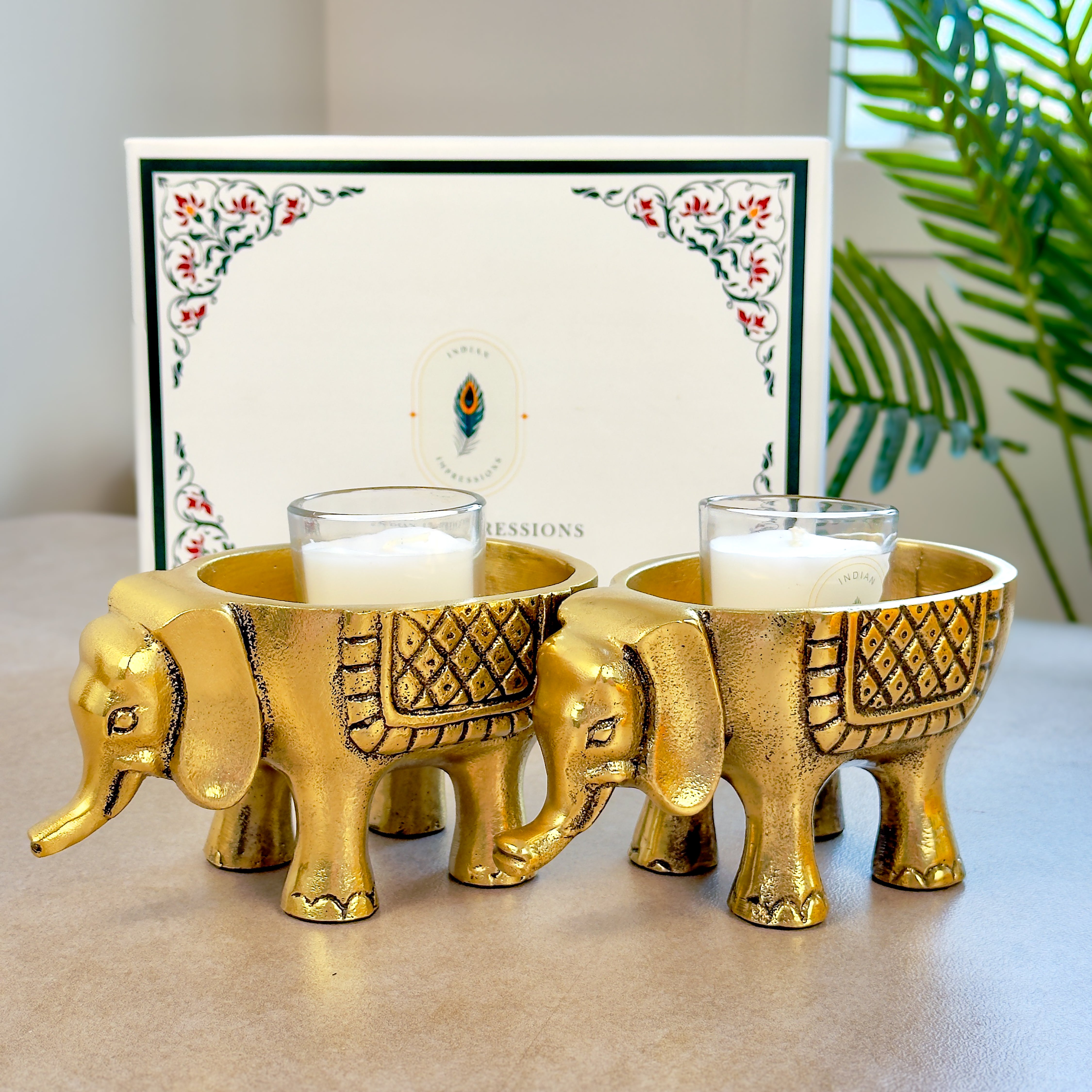 Product image of an Elephant Antique Brass Finish figurine from Indian Impressions, intricately crafted with detailed features. The elephant, symbolizing strength, wisdom, and good luck, is finished in a rich antique brass tone. The figurine comes with a gift box, making it an ideal gift for home décor, spiritual practices, or Vastu.