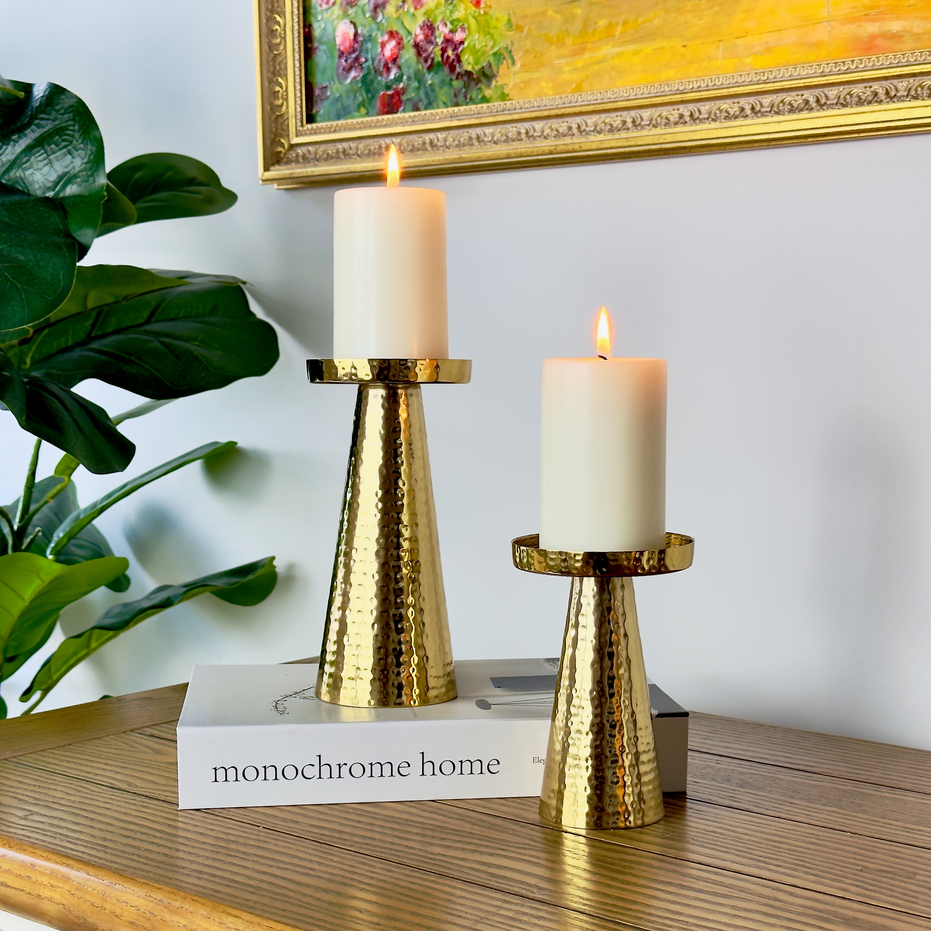 Product image of a Metal Candle Holder Set of 2 from Indian Impressions, featuring elegantly crafted holders with a hammered finish. Designed for pillar or taper candles, these holders add a touch of sophistication to any setting. Perfect for Vastu, home décor, festive occasions, or gifting.