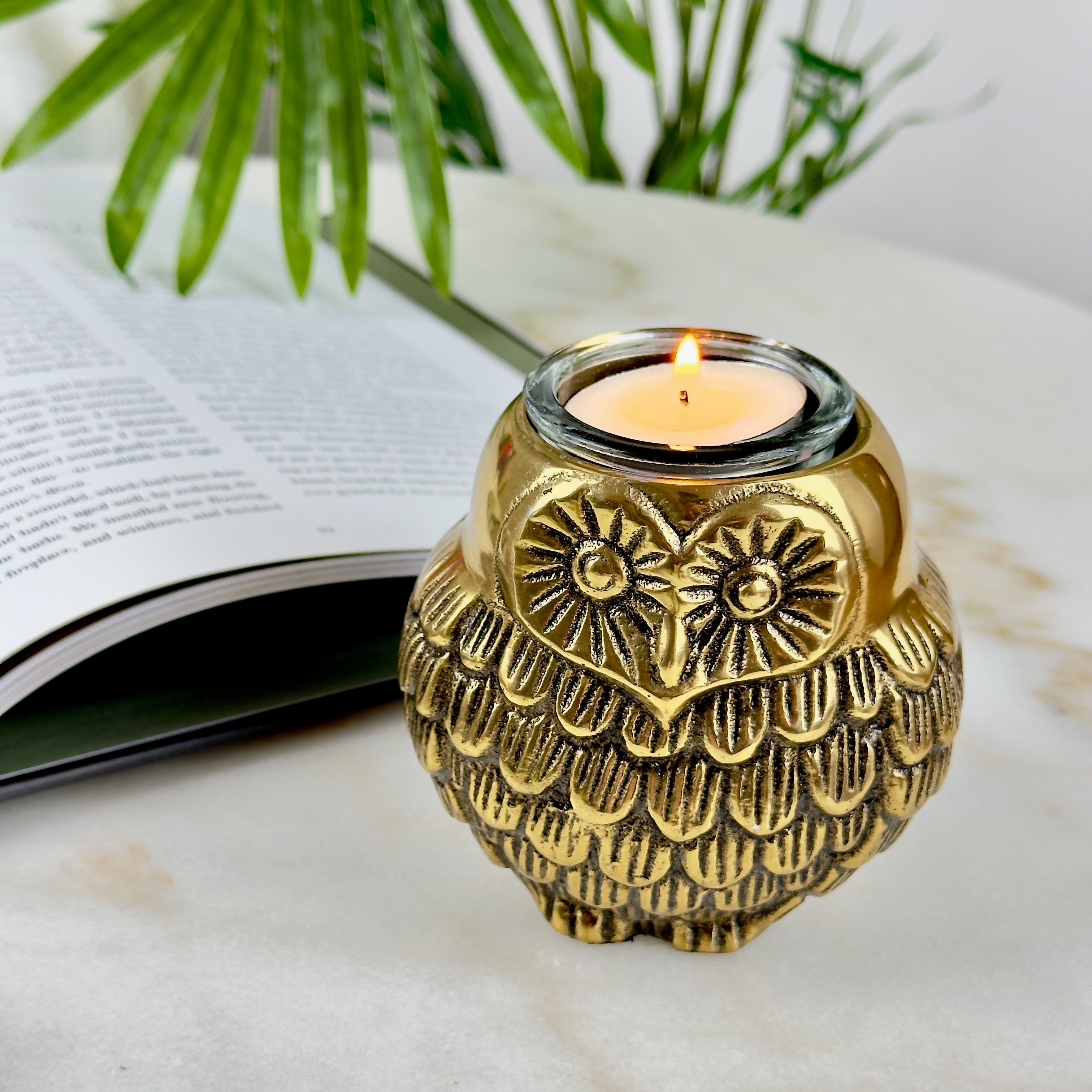 Product image of the Owl Figurine Pair Tea light Holder with Antique Brass Finish from Indian Impressions, featuring two intricately designed owl statues with detailed craftsmanship. Symbolizing wisdom and protection, these figurines are ideal for Vastu, home décor, or gifting, adding a touch of charm and positive energy to any space.