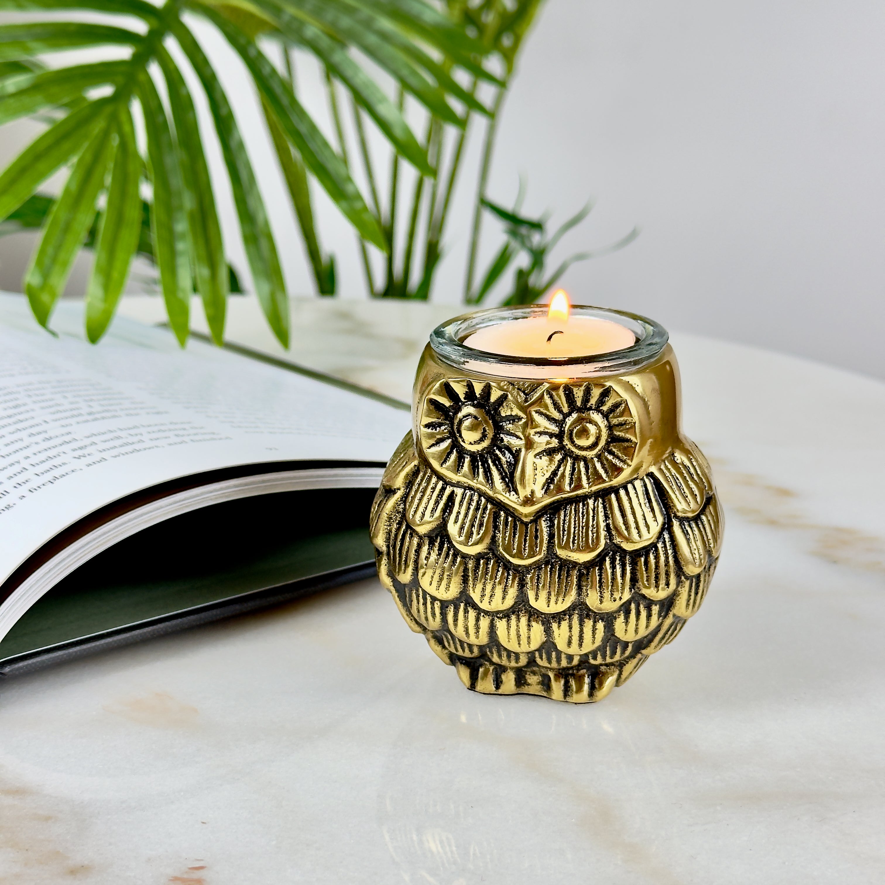 Product image of the Owl Figurine Pair Tea light Holder with Antique Brass Finish from Indian Impressions, featuring two intricately designed owl statues with detailed craftsmanship. Symbolizing wisdom and protection, these figurines are ideal for Vastu, home décor, or gifting, adding a touch of charm and positive energy to any space.