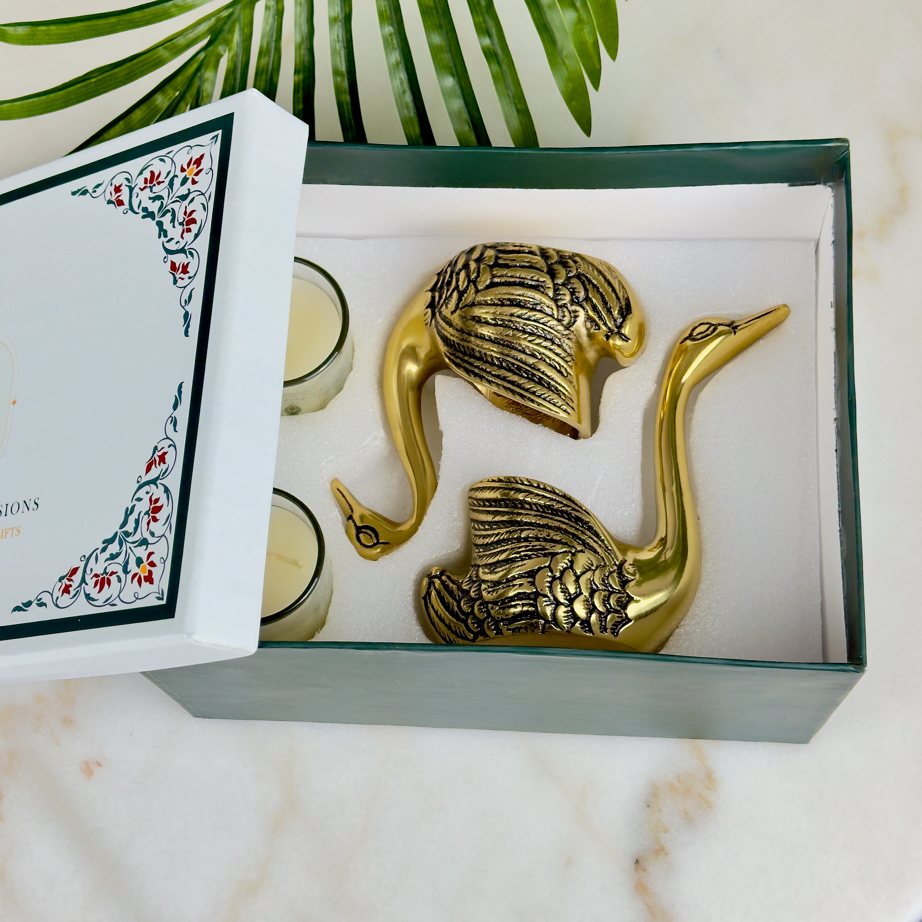 Product image of the Swan Figurine Candle Holder Pair in Gold from Indian Impressions, showcasing two intricately crafted swan-shaped candle holders with a polished gold finish. Ideal for holding candles, this elegant pair is perfect for Vastu, home décor, festive occasions, or gifting, adding sophistication and charm to any space.