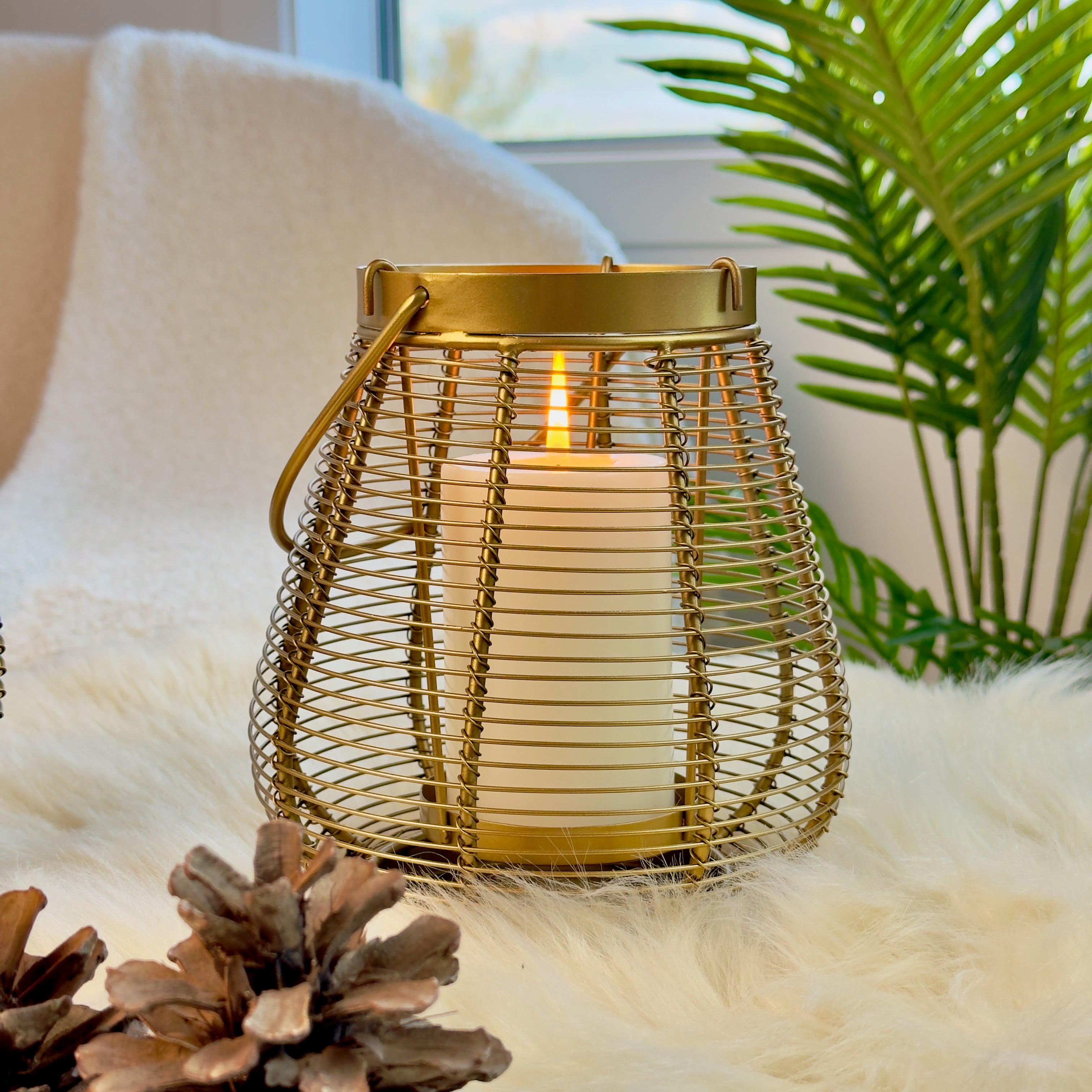 Product image of a Metal Cage Lantern from Indian Impressions, featuring a sleek, openwork cage design with a polished finish. This lantern is ideal for holding candles or LED lights, adding a warm and elegant ambiance to any space. Perfect for Vastu, home décor, or gifting.