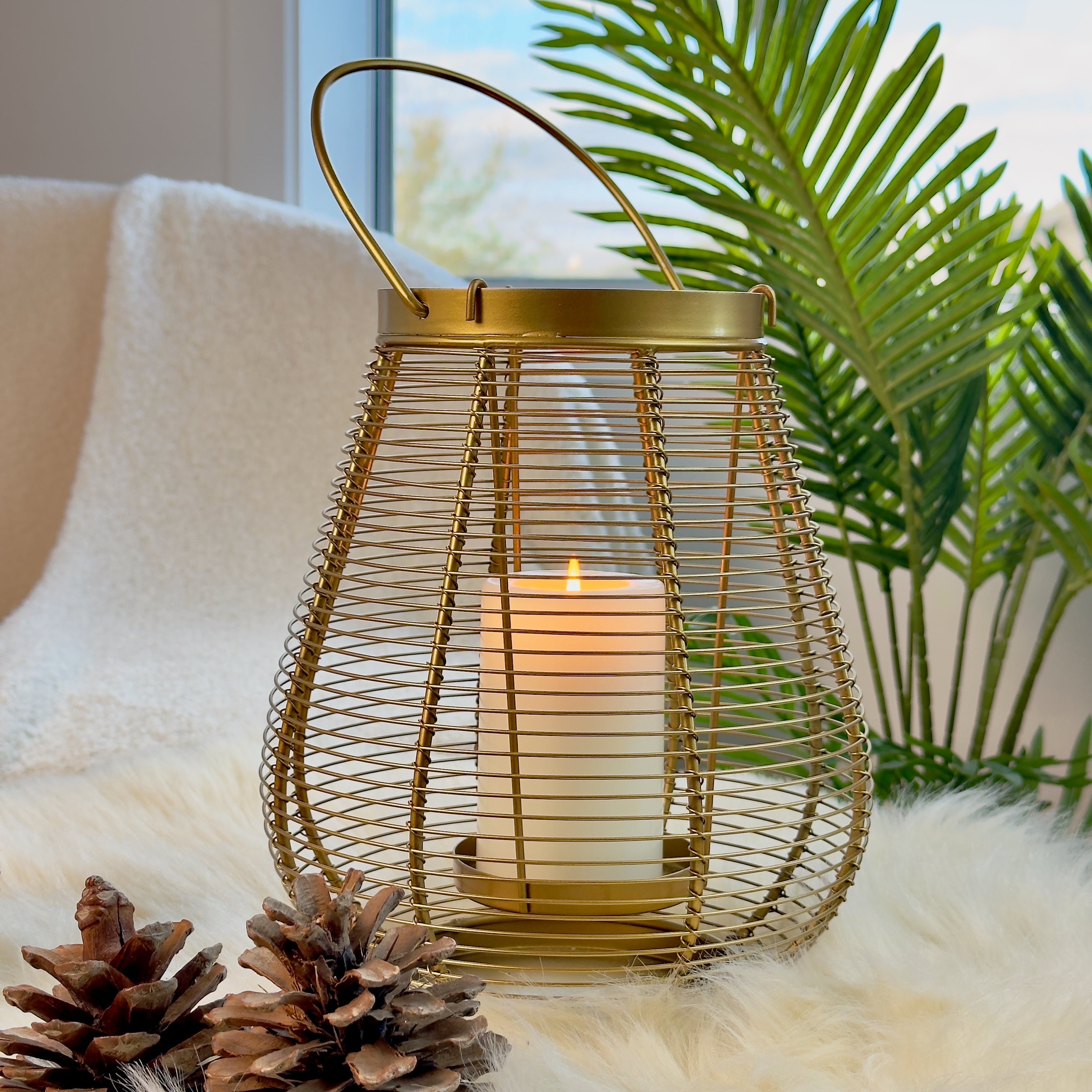 Product image of a Metal Cage Lantern from Indian Impressions, featuring a sleek, openwork cage design with a polished finish. This lantern is ideal for holding candles or LED lights, adding a warm and elegant ambiance to any space. Perfect for Vastu, home décor, or gifting.
