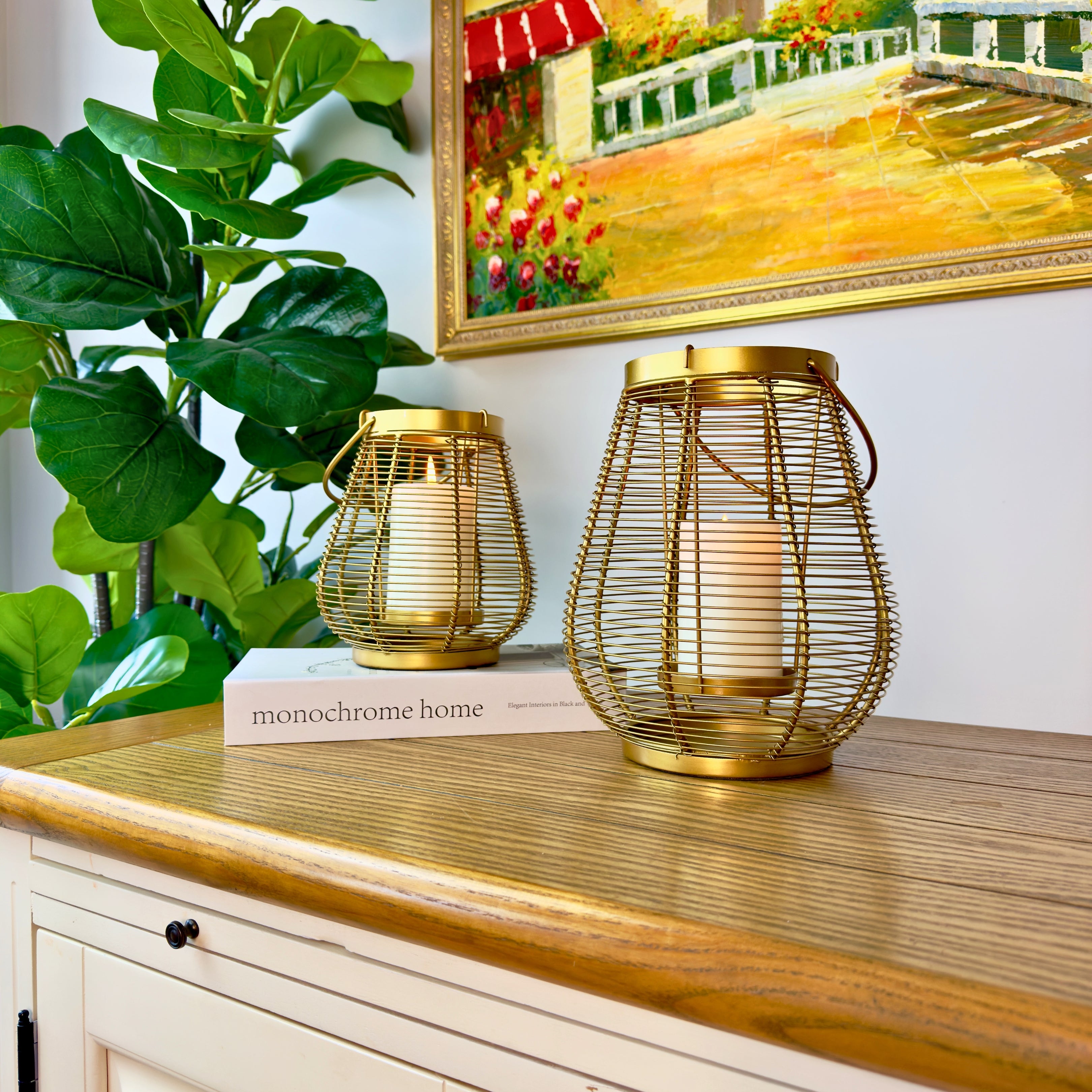 Product image of a Metal Cage Lantern from Indian Impressions, featuring a sleek, openwork cage design with a polished finish. This lantern is ideal for holding candles or LED lights, adding a warm and elegant ambiance to any space. Perfect for Vastu, home décor, or gifting.