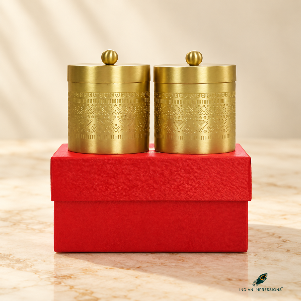 Pair of engraved brass jars with lids on red gift box